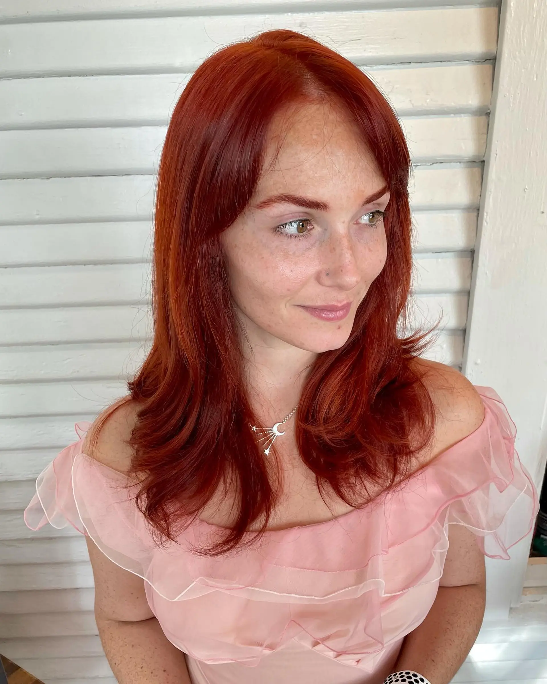 Vibrant copper-red medium-length hair with face-framing fringe and lightly flicked ends. 1