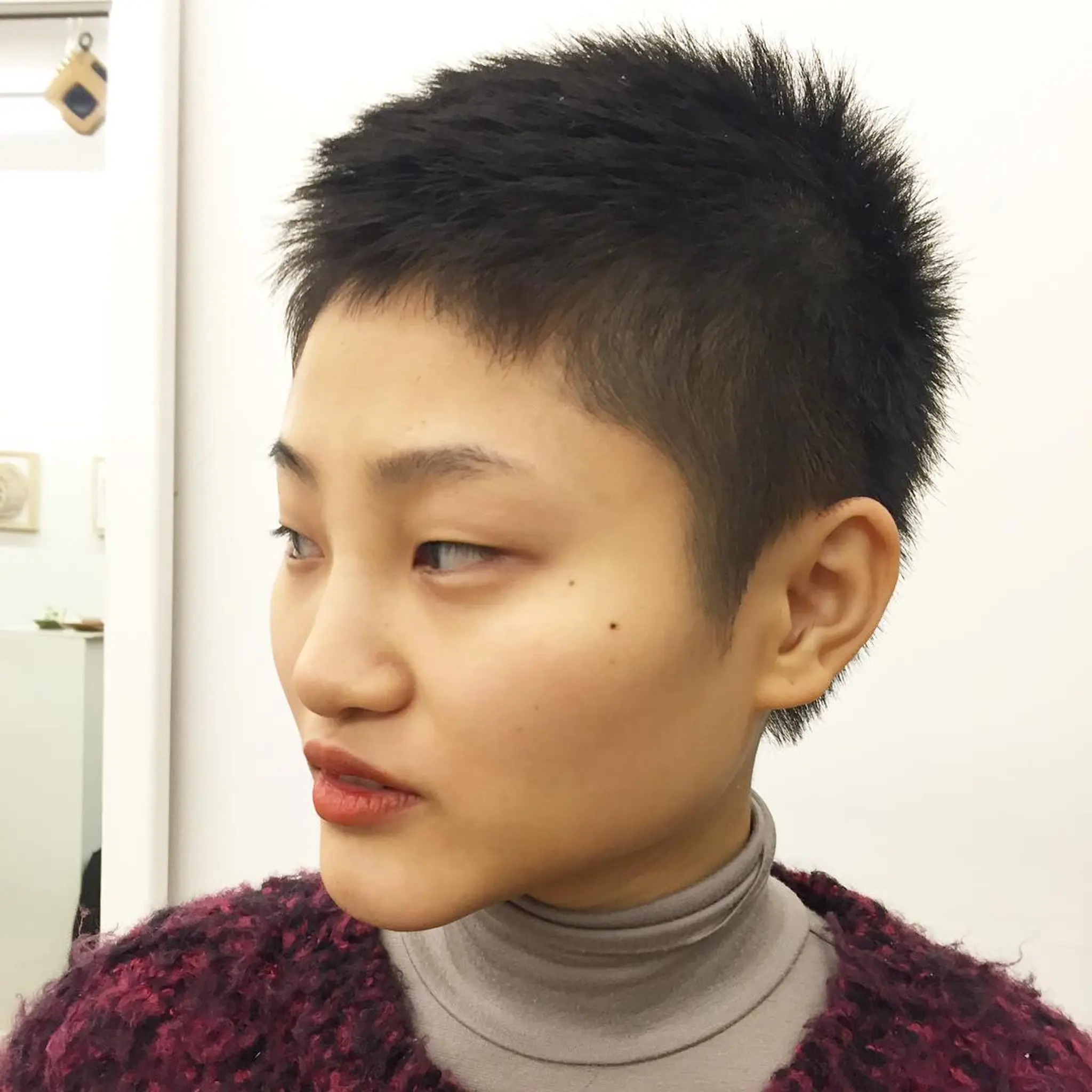 A natural crewcut cut with very short, straight black hair, designed for a bold and confident look by Takeo.