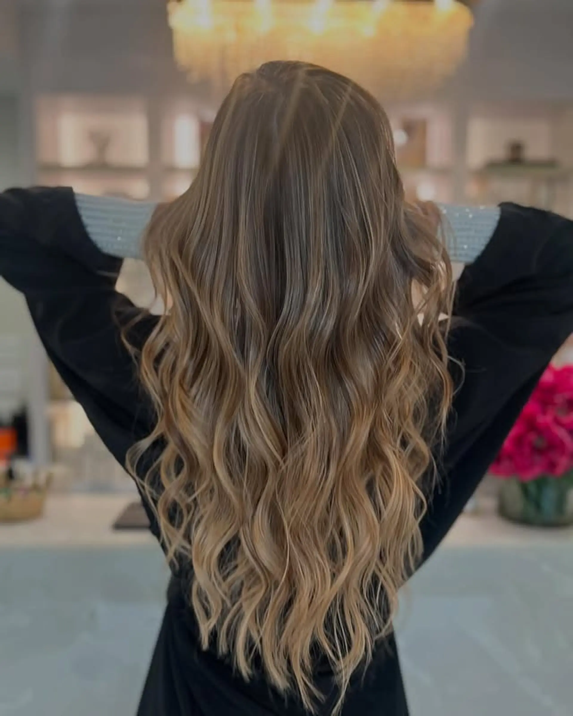 Long wavy hair with a smooth balayage transition from brown to blonde. 1