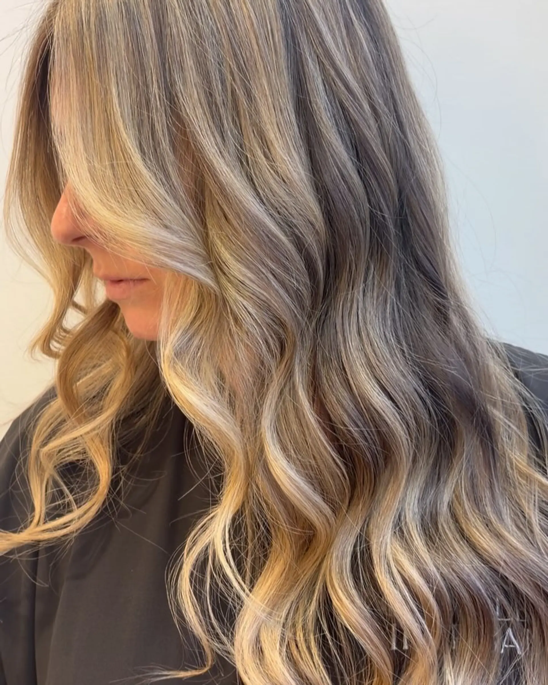 Long beige blonde balayage styled with soft, loose waves and bright face-framing ribbons. 1