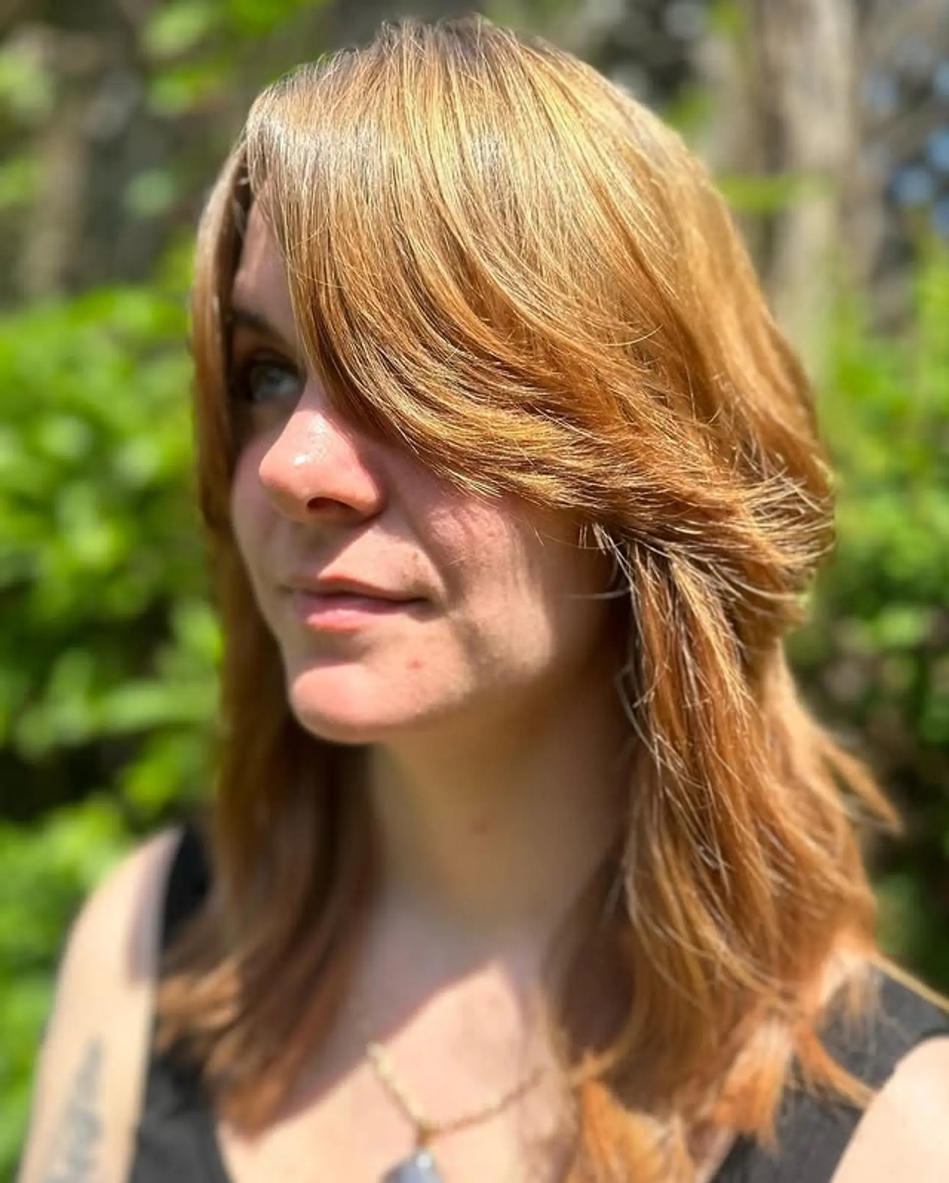 A medium-length shag with layers and curtain bangs. 1