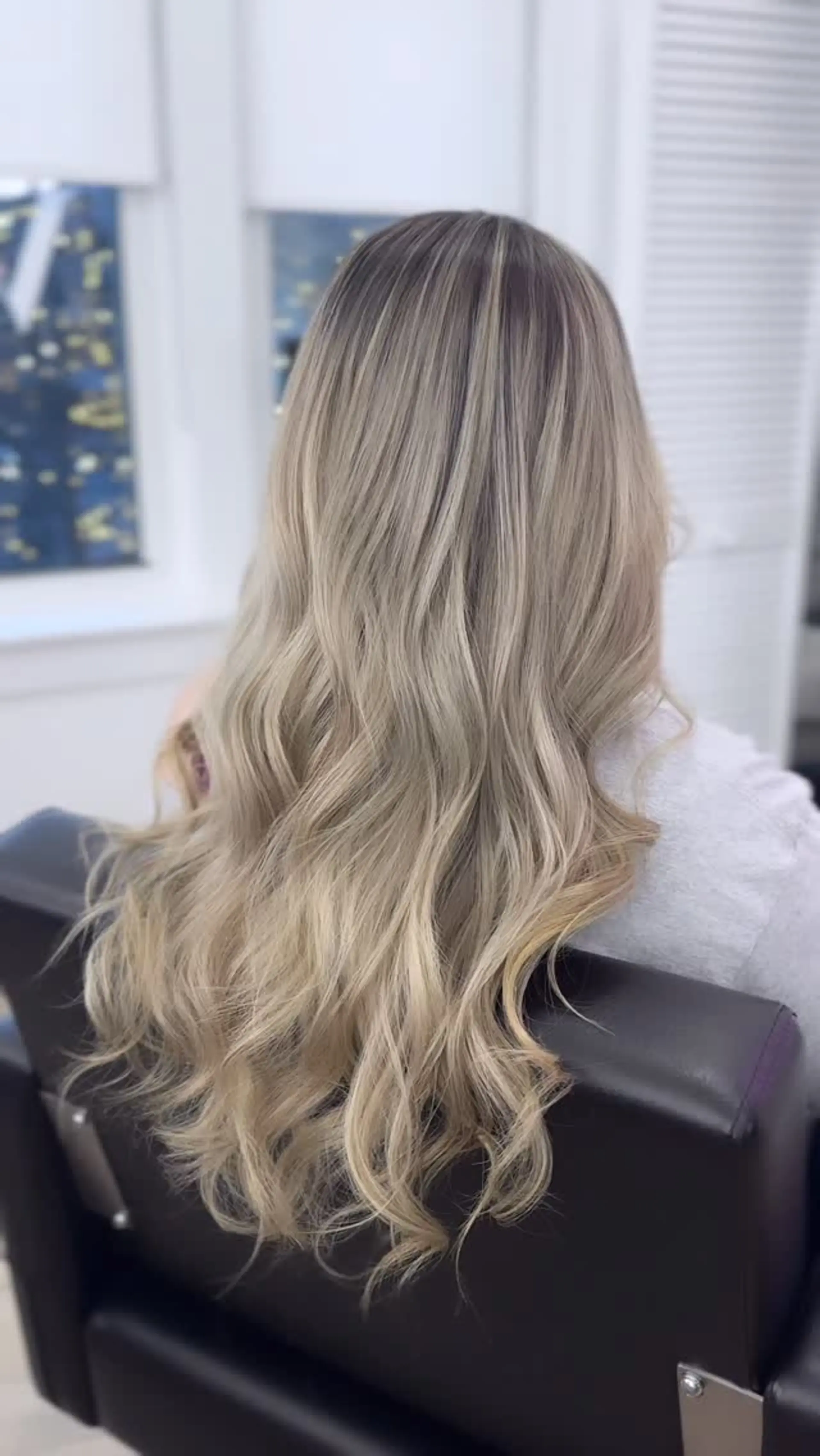 Long ash blonde hair featuring a shadowed root transition and soft, flowing waves. 1