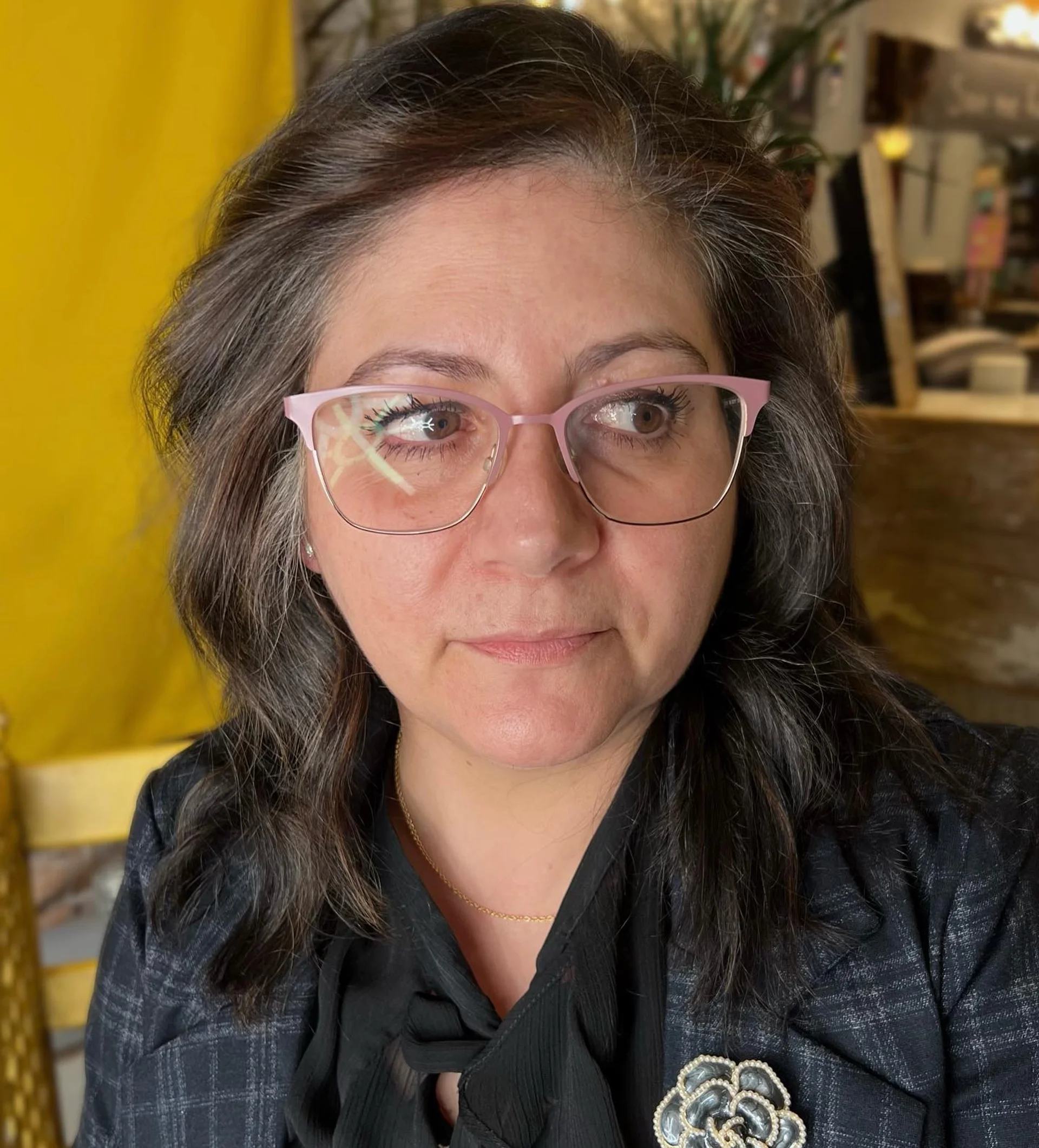 Softly blended gray coverage on long wavy hair with subtle highlights - Preview 1