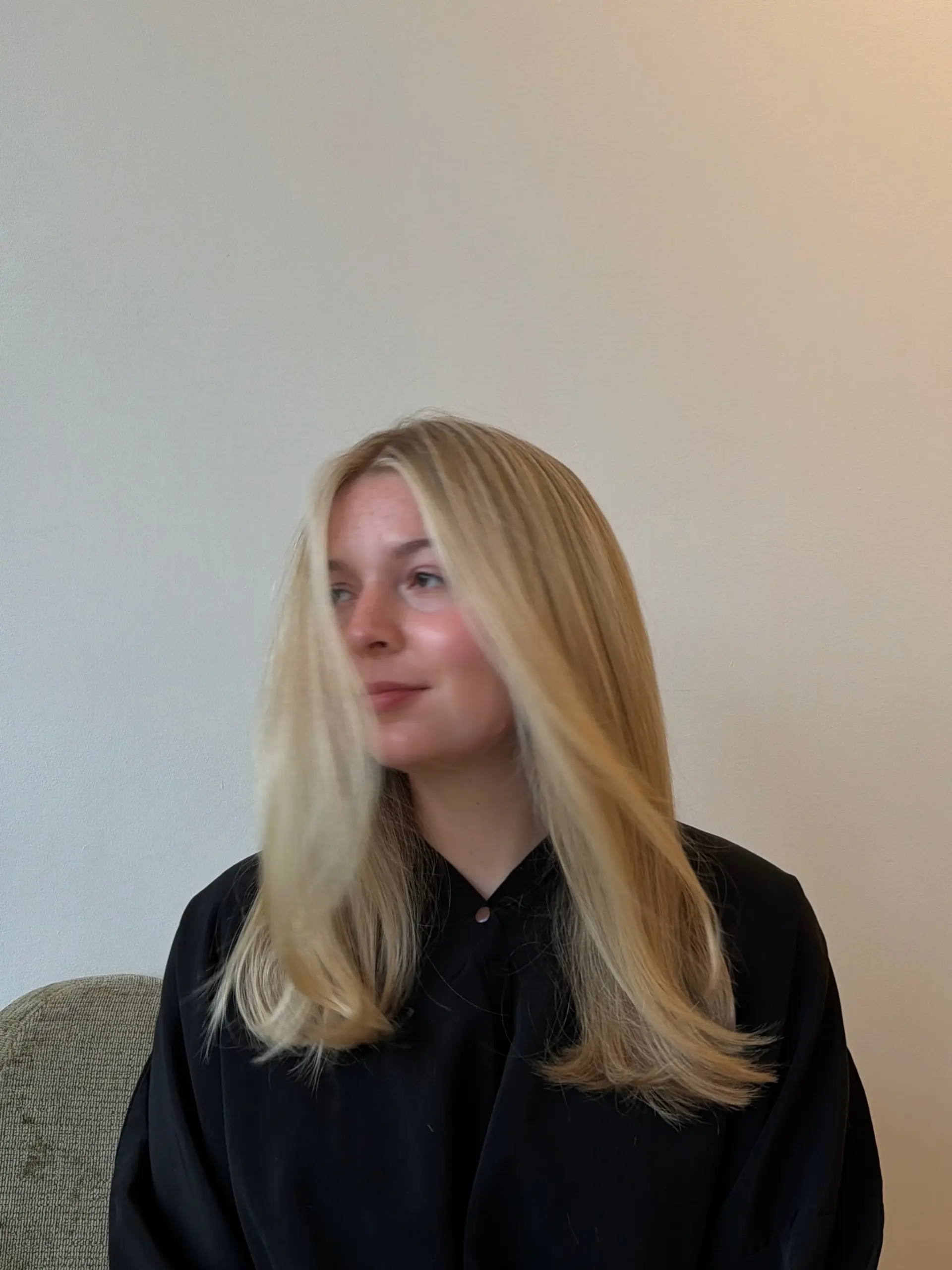 Silky, bright blonde hair styled with a smooth blowout and soft, dynamic movement around the face. 1