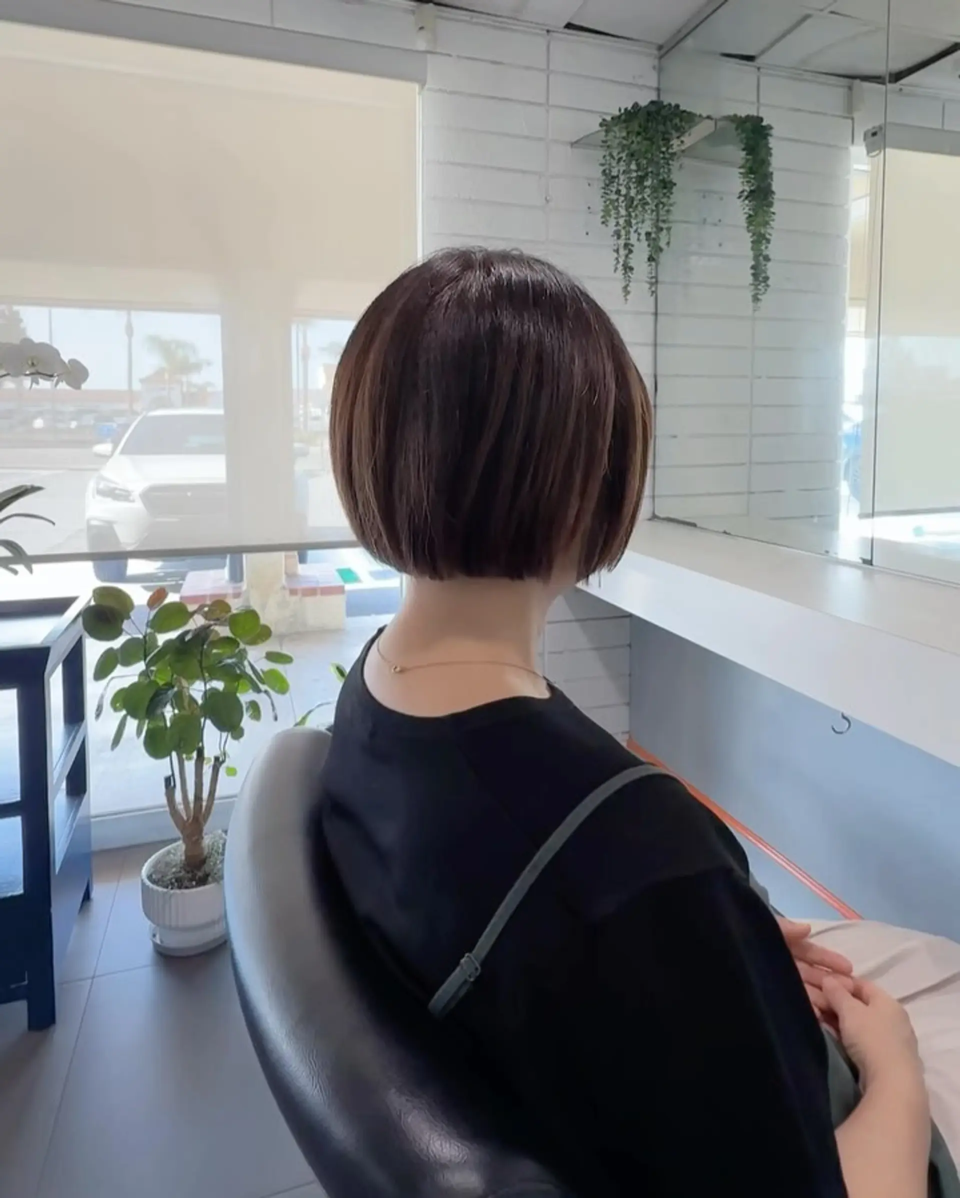 A sleek, rounded short bob with subtle volume and a clean blunt cut along the nape. 1
