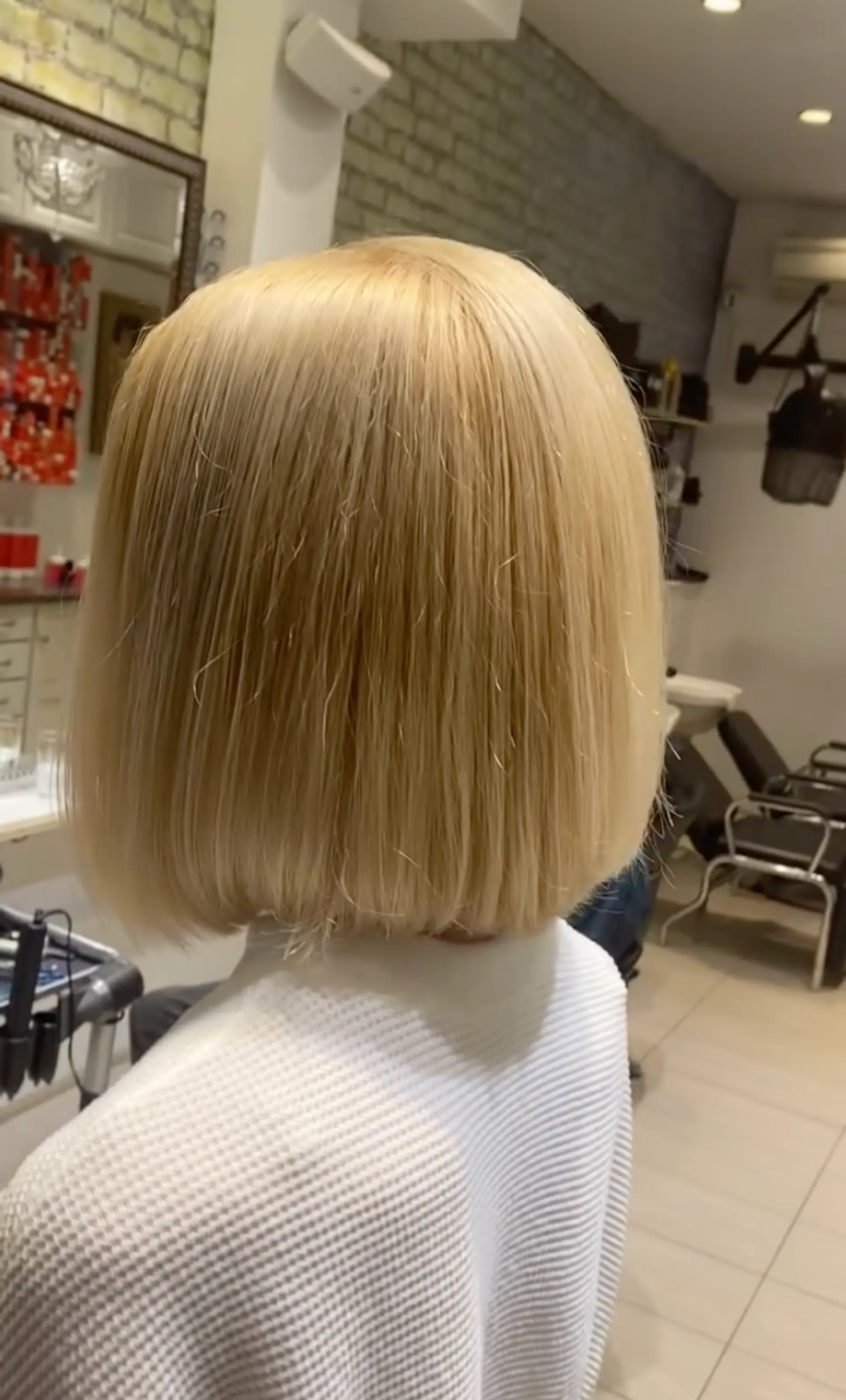 A short, blunt bob with a clean, straight cut. 1