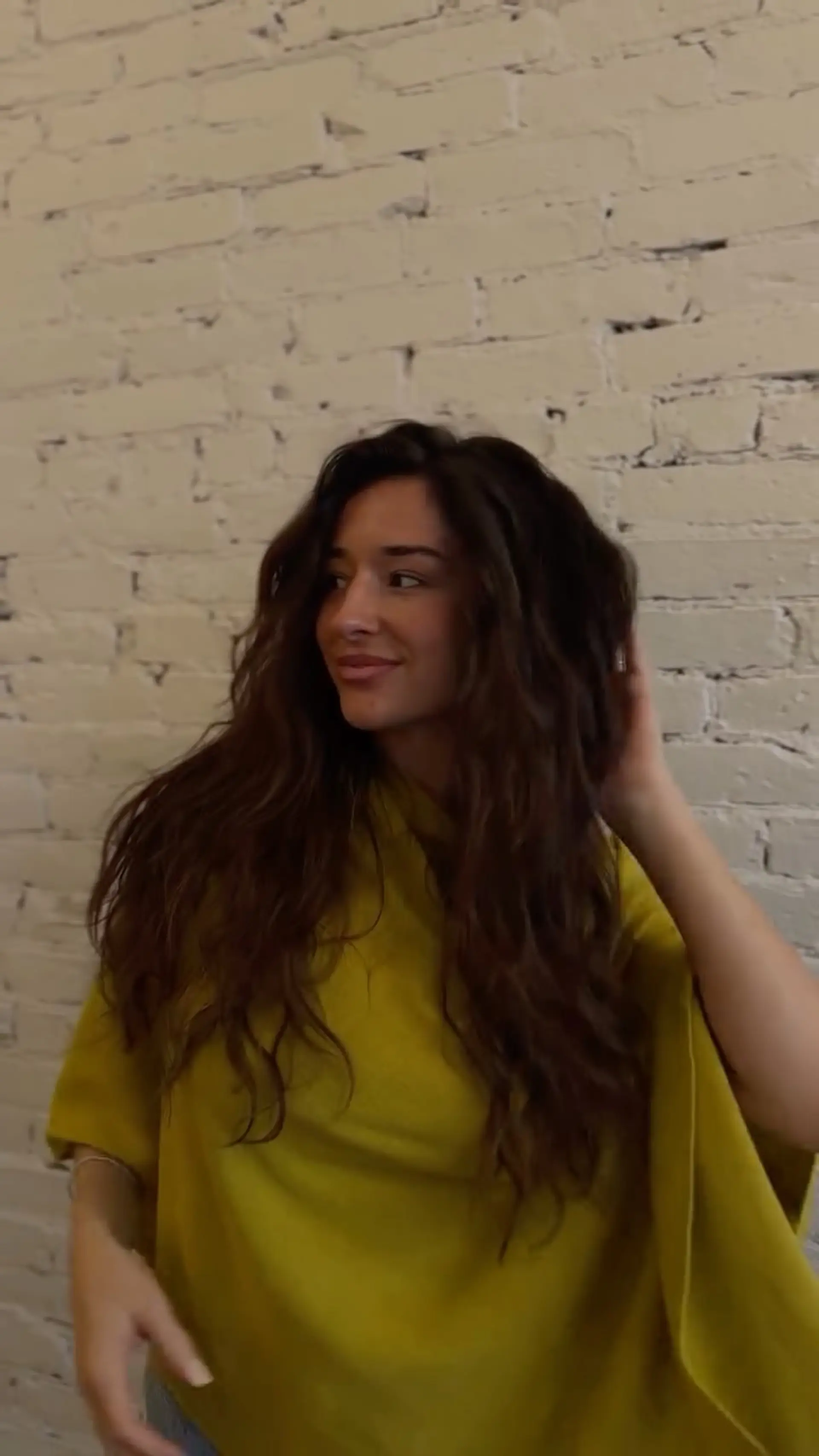 Voluminous, naturally wavy long dark brown hair styled with an airy, soft texture. 1