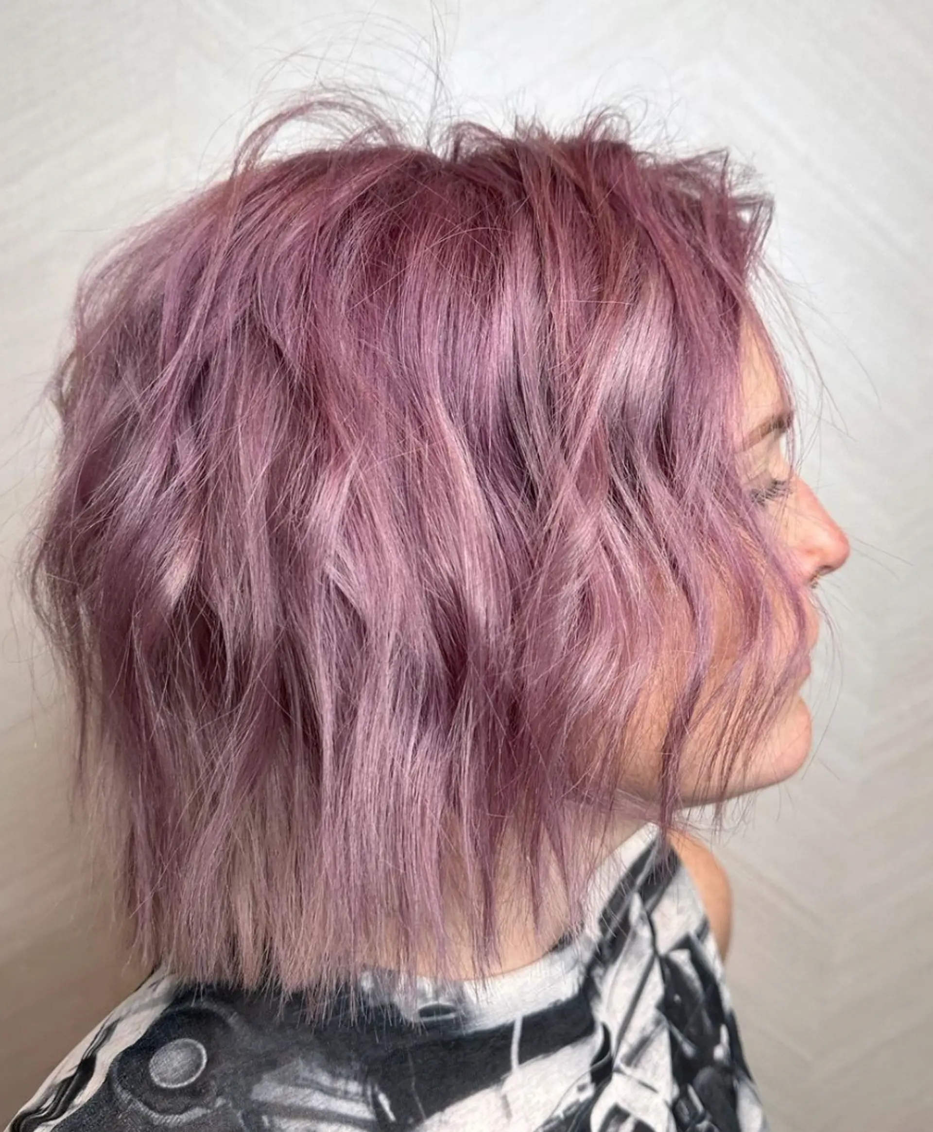 A short, textured bob with wavy, pastel lavender and pink hair that adds movement and depth. The overall style is chic and fashion-forward, featuring layers that enhance volume and visual interest.

Color by @simabeautynyc
Cut and style by @juliamannino_hair
 1