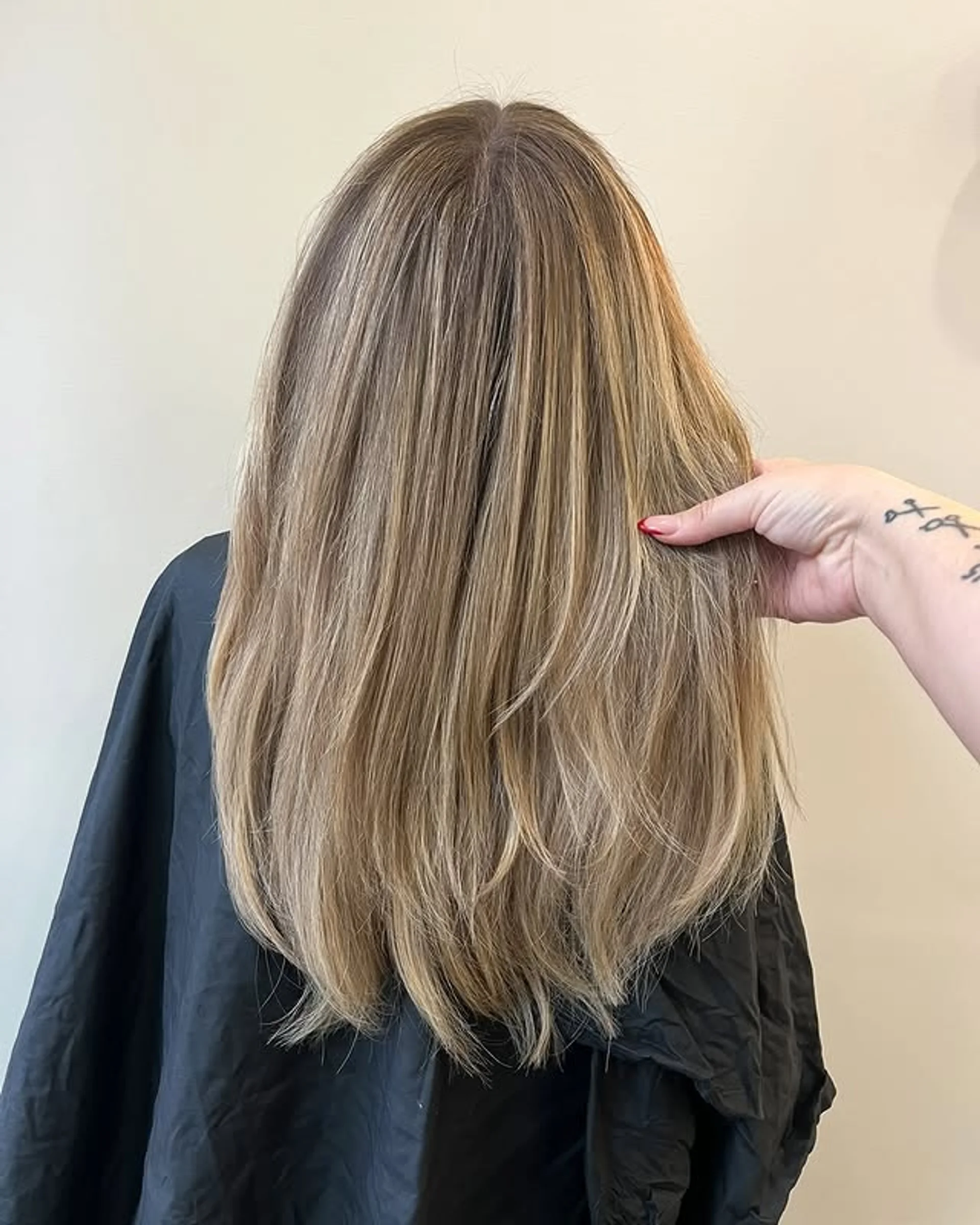A woman with incredibly shiny, long, straight brunette hair, exemplifying the 2026 'Glass Hair' trend in NYC. - Preview 3