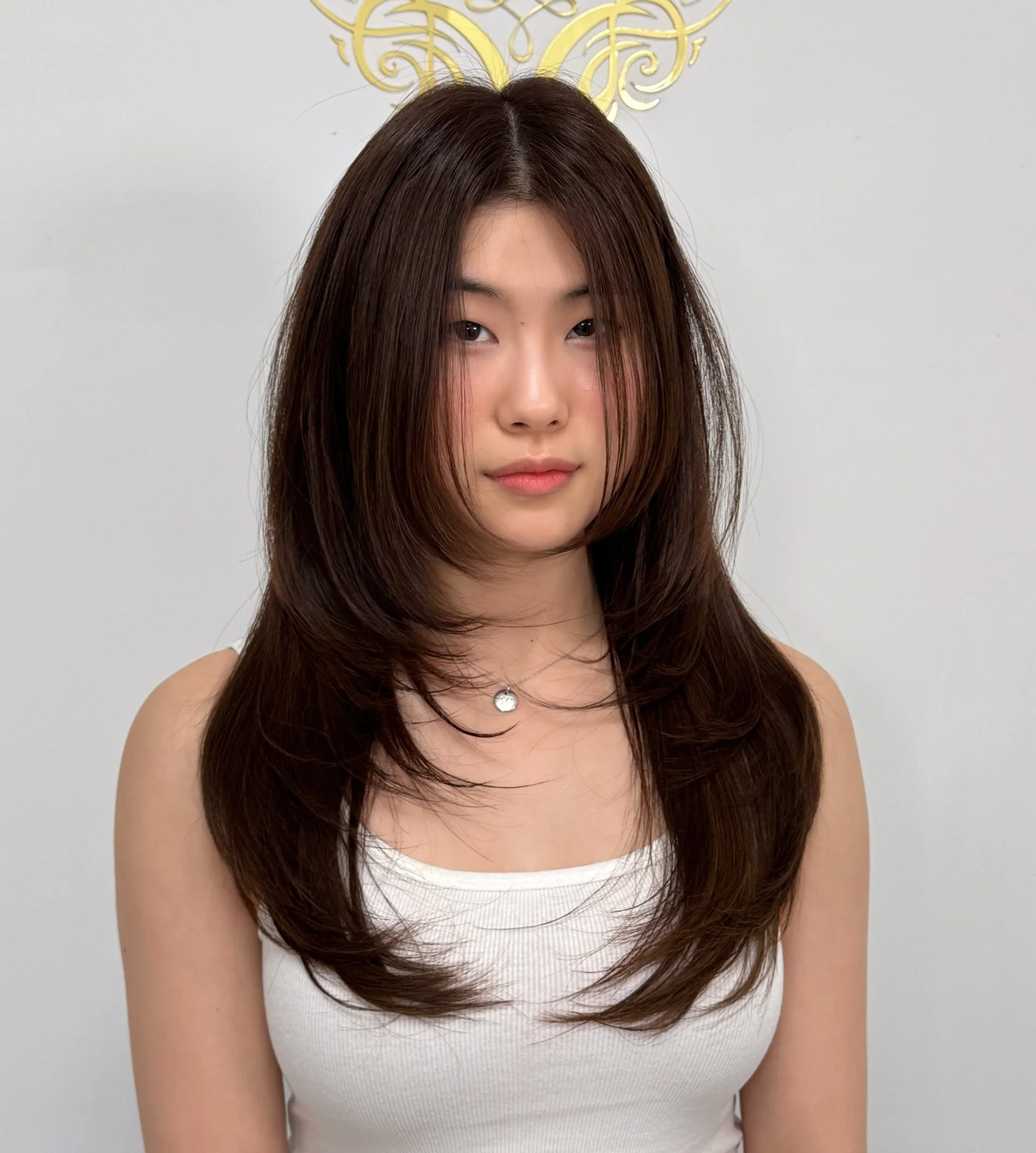 Modern brunette butterfly haircut showcasing cascading layers and expressive volume - Preview 3