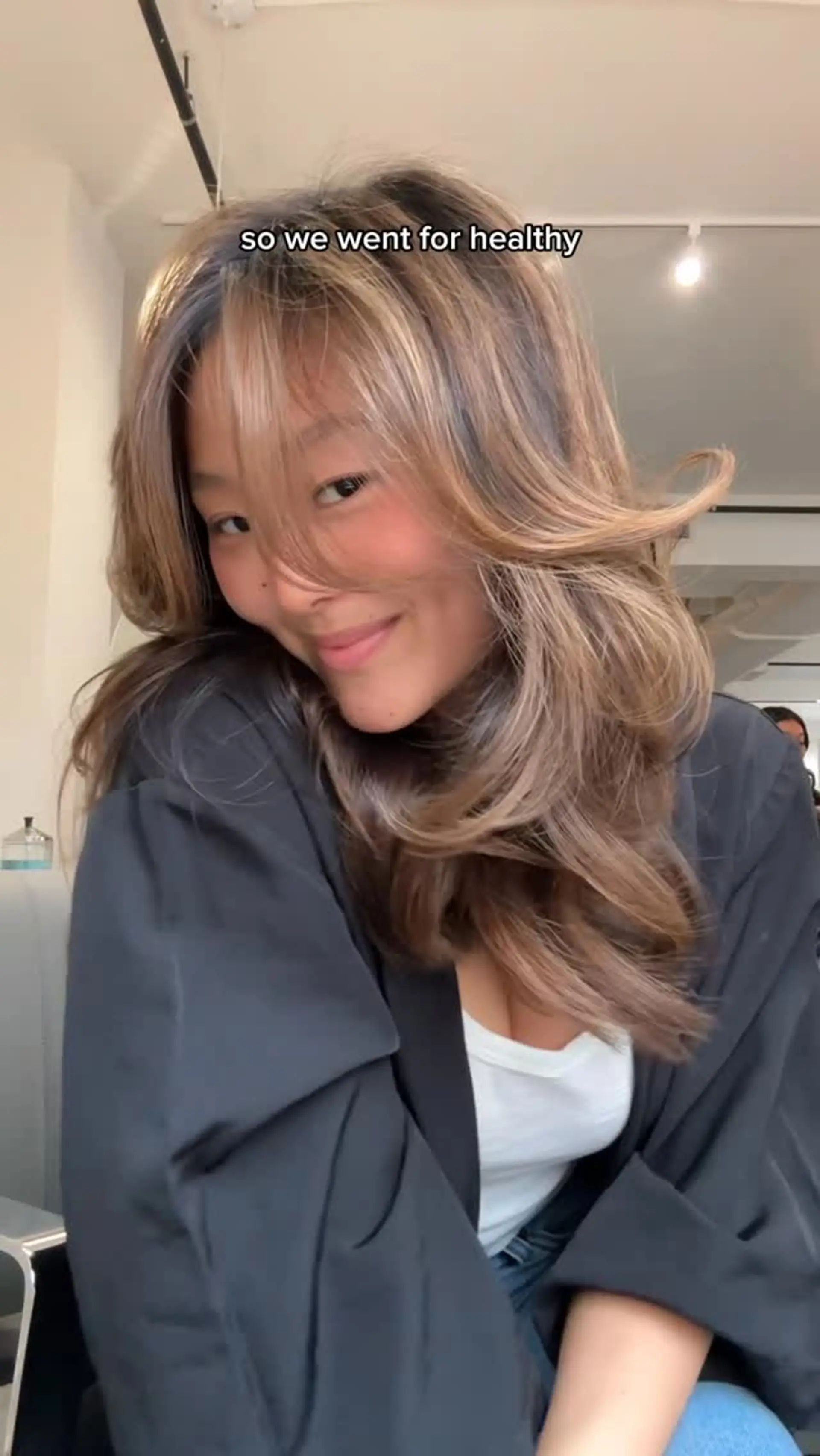 Long honey brown hair styled with voluminous cascading layers and soft curtain bangs. 1