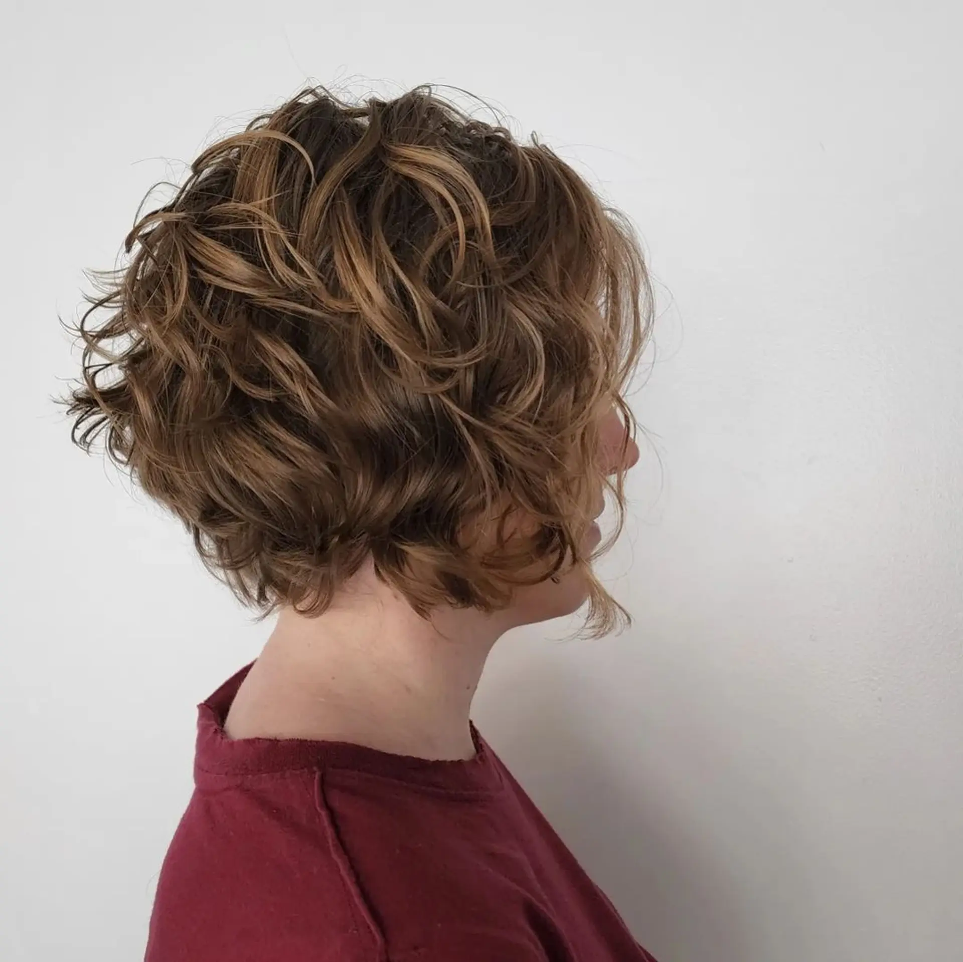 Daring combination of shaved sides with two line designs and longer wavy strands on top for a bold, modern effect. 3