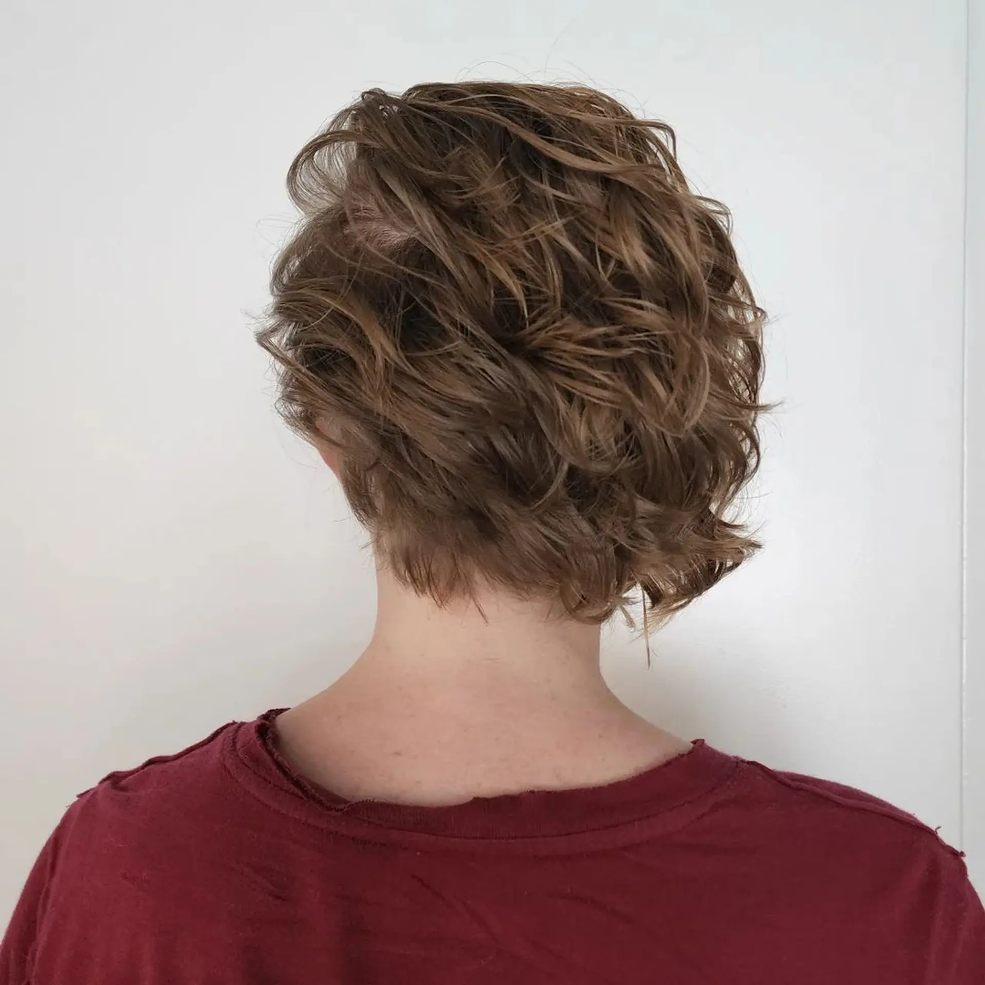 Daring combination of shaved sides with two line designs and longer wavy strands on top for a bold, modern effect. 4