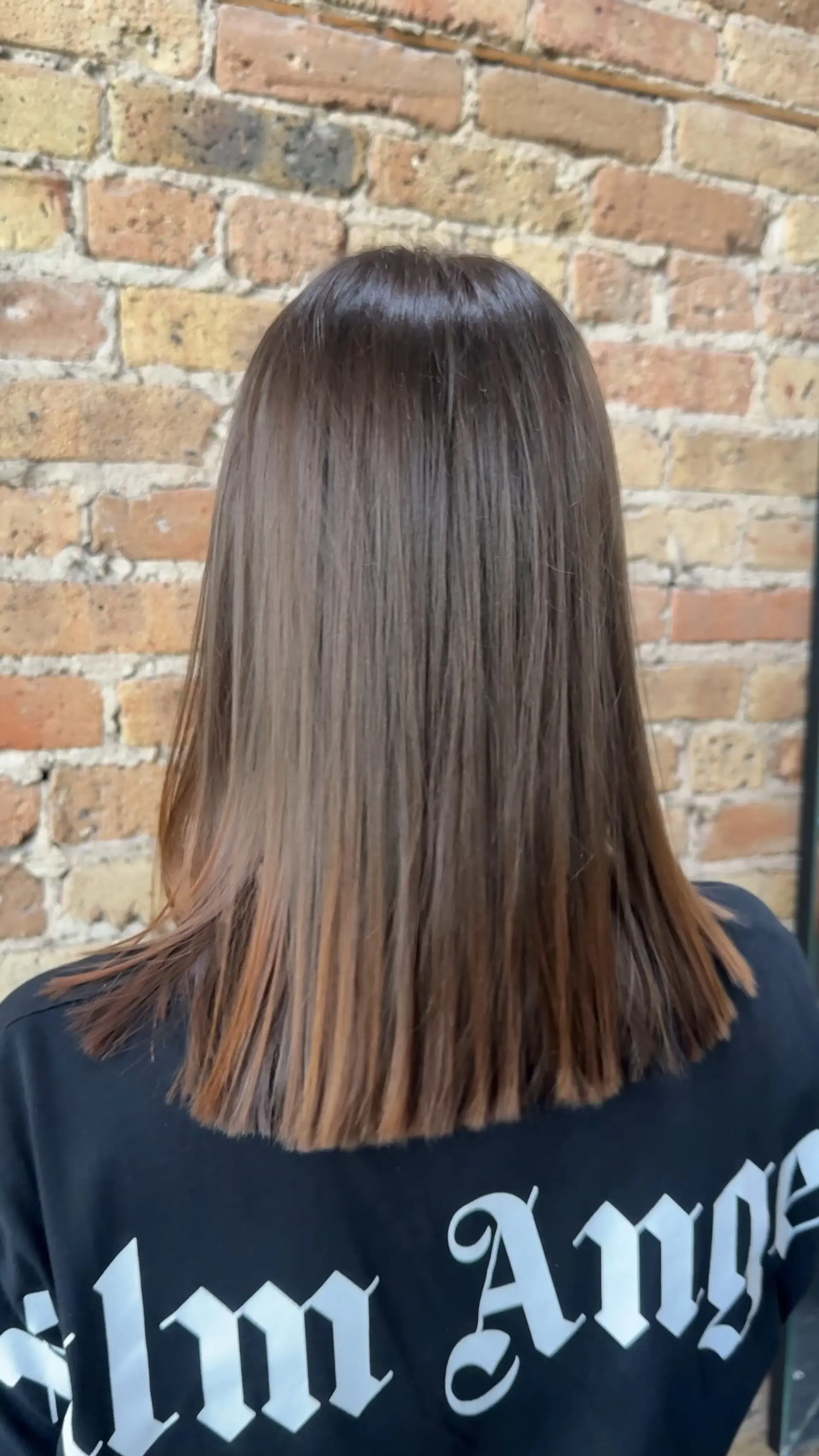 A sleek, straight medium-length lob featuring a sharp, blunt baseline across the upper back. 1