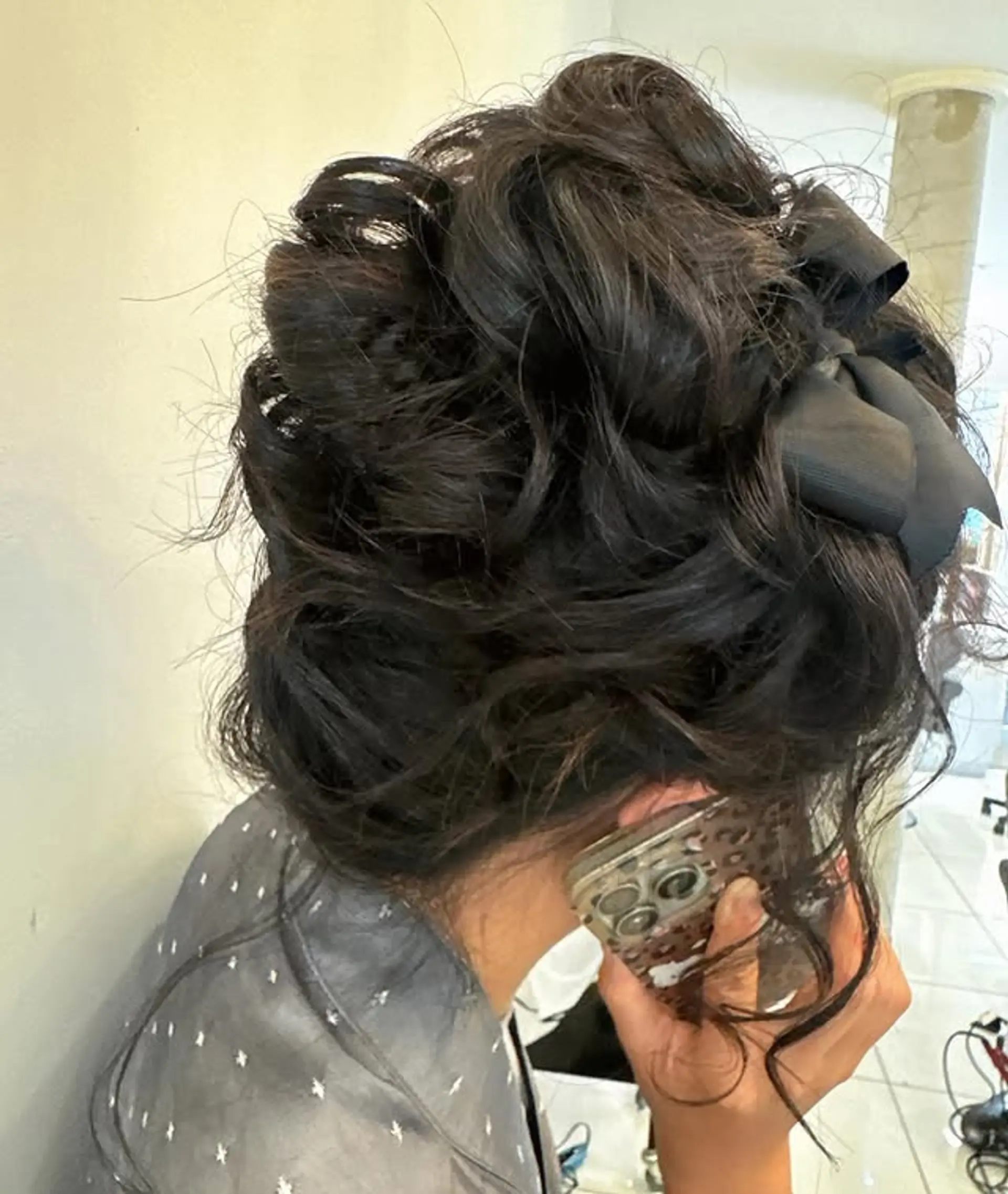 A romantic updo with soft waves and a ribbon accent. 1