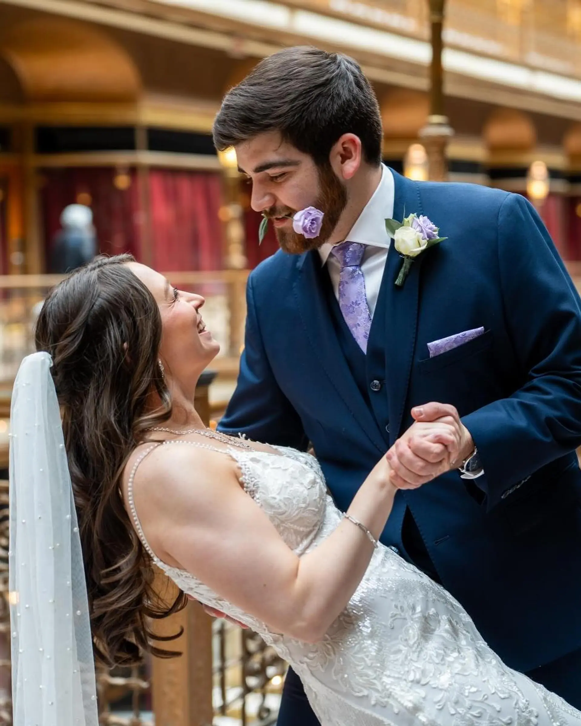 Soft, polished cascading waves styled with an elegant bridal veil, complemented by a tailored, neat groom haircut. 1