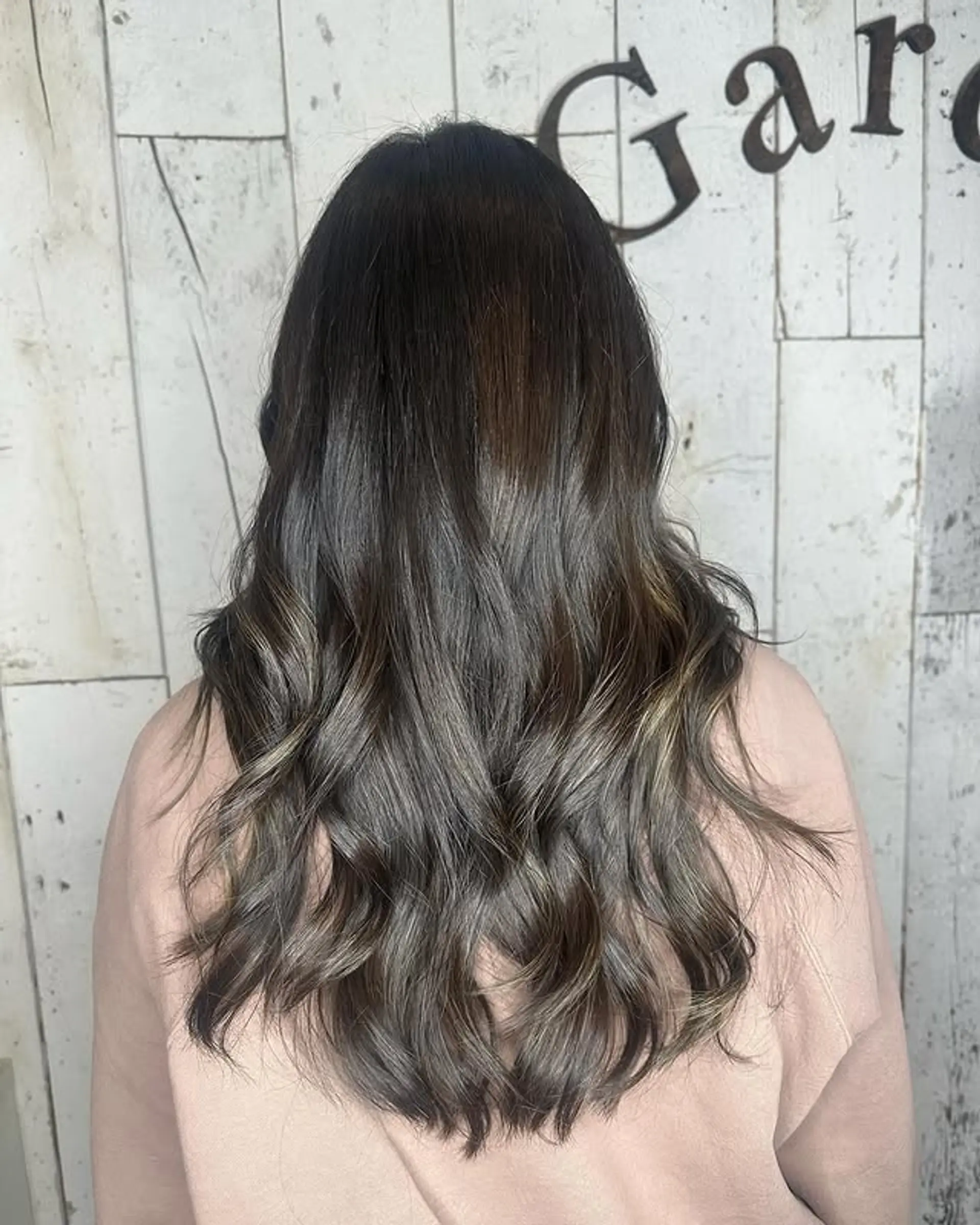 Long, wavy hair with a dark base and icy blonde balayage highlights. 1