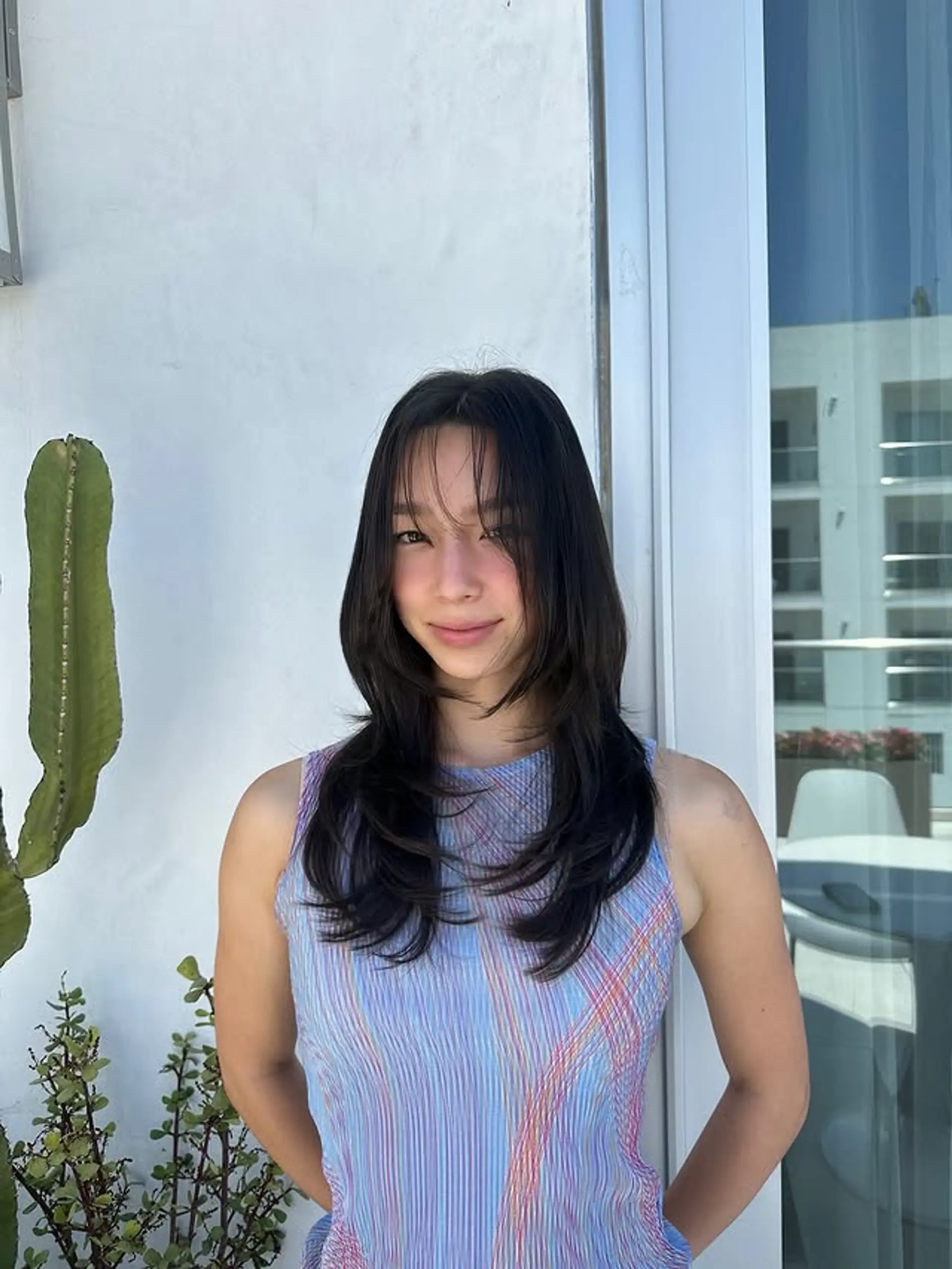 A medium-length shag haircut with soft, face-framing layers and curtain bangs. 1