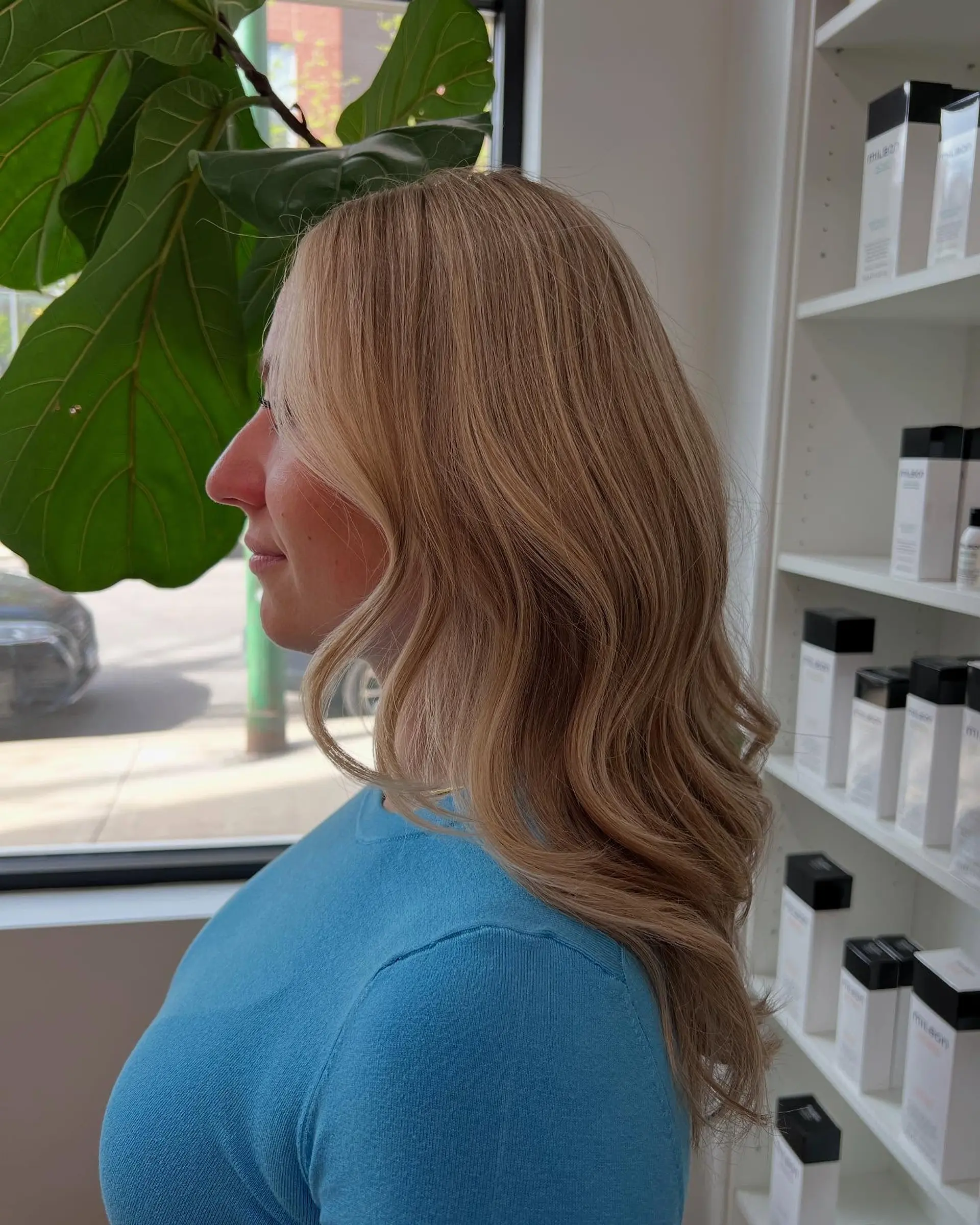 Long dimensional blonde hair styled in smooth, loose waves with face-framing pieces. 1