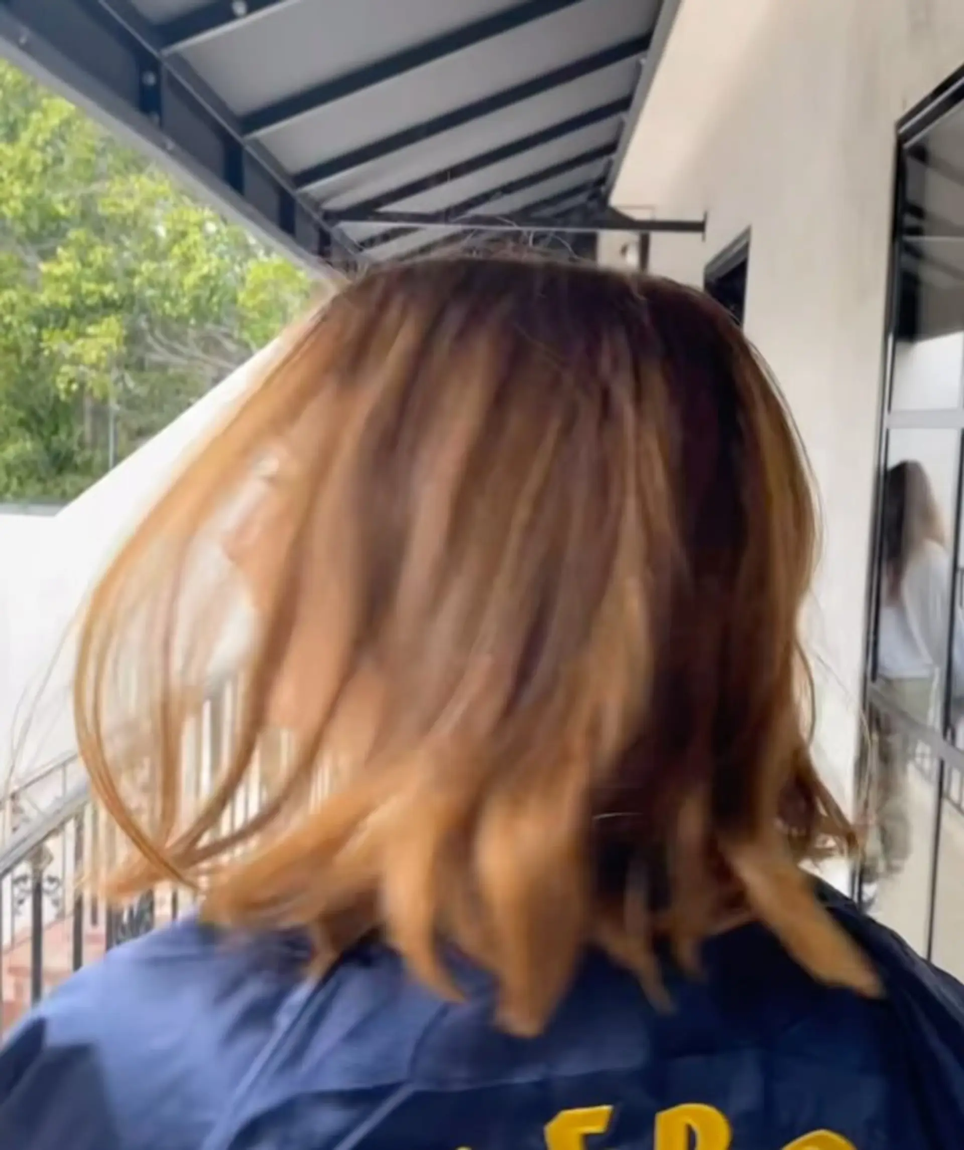 A textured medium-length bob featuring warm caramel and honey highlights over a deep brown base. 1