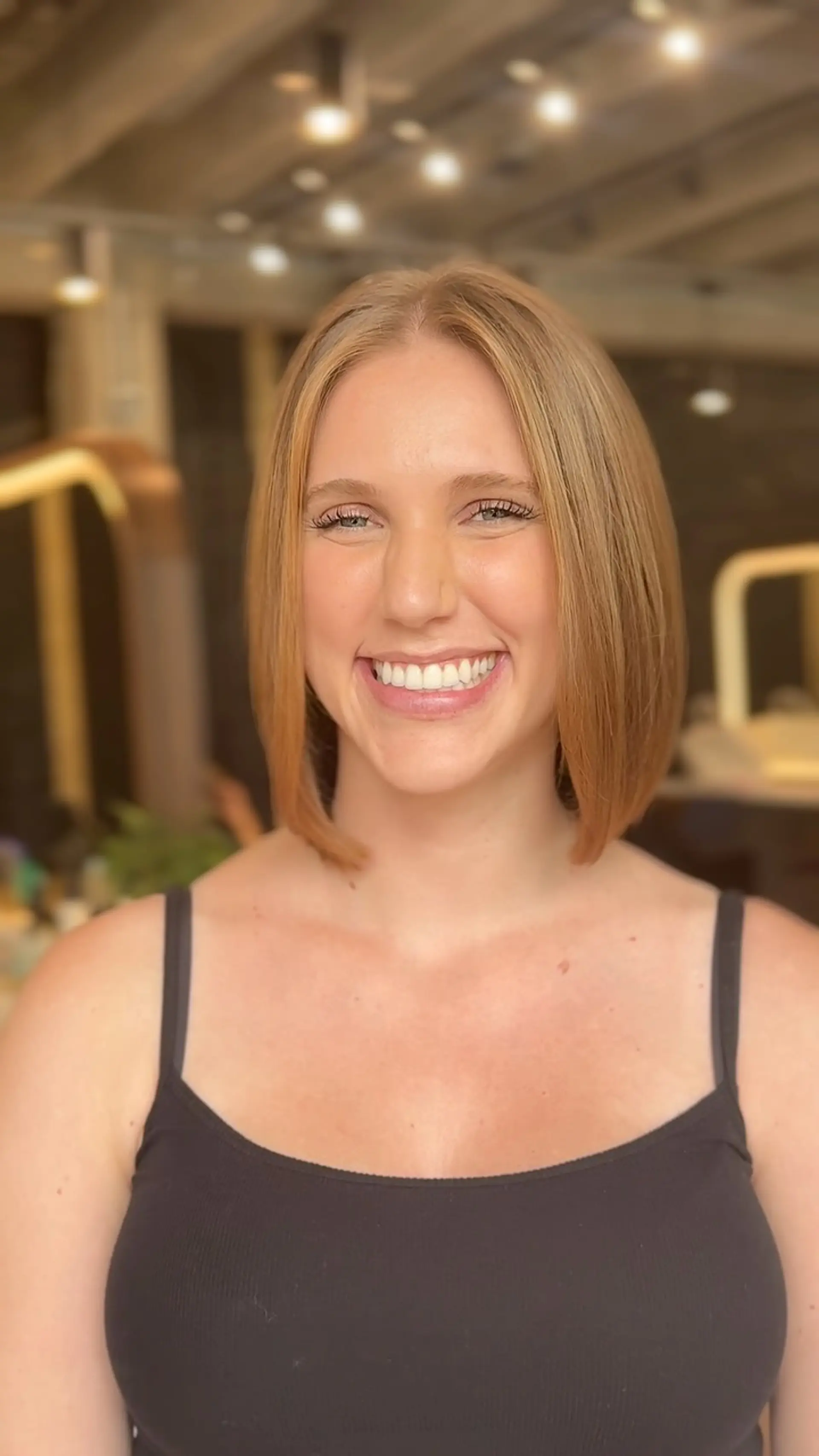 A sleek, collarbone-length blunt lob styled straight with softly bevelled ends and a center part. 1