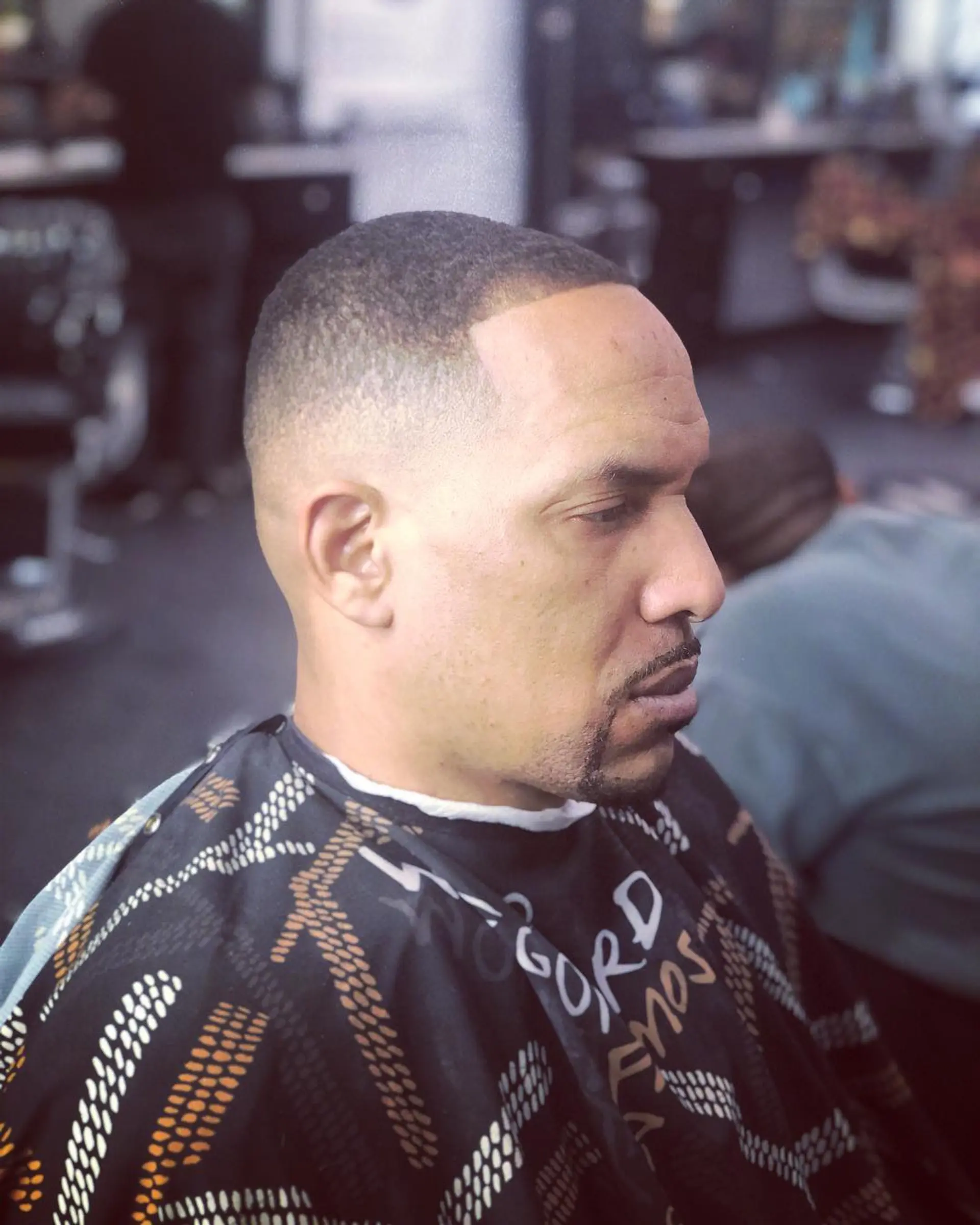 A tight buzz cut paired with a high skin fade and a crisp hairline shape up. 1