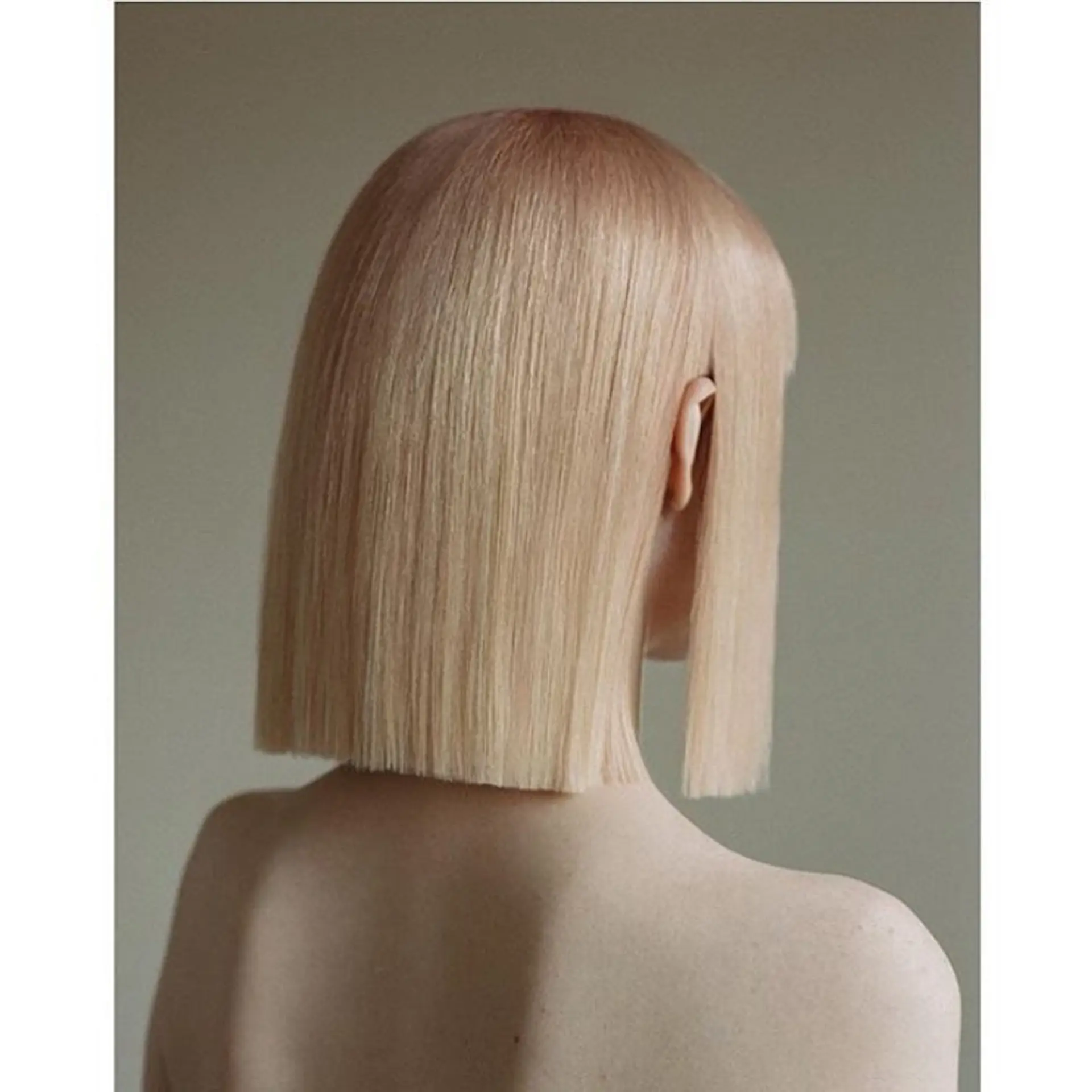 A sleek, blunt-cut platinum blonde style with sharp edges and a modern, minimalistic appeal. 1