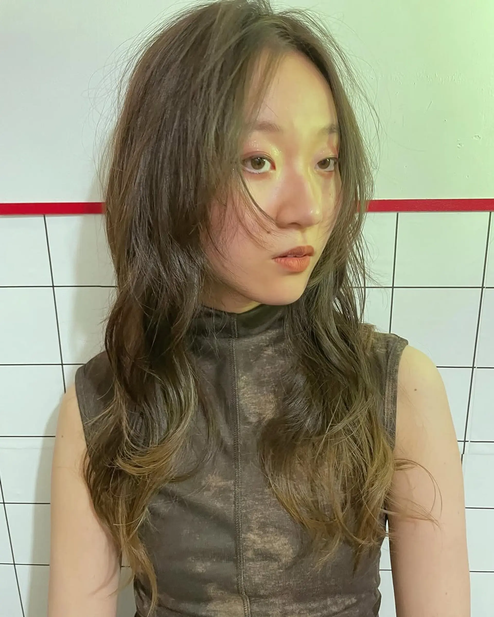 A textured, long shag cut featuring soft, wispy layers throughout the lengths and flattering, face-framing curtain bangs. 1