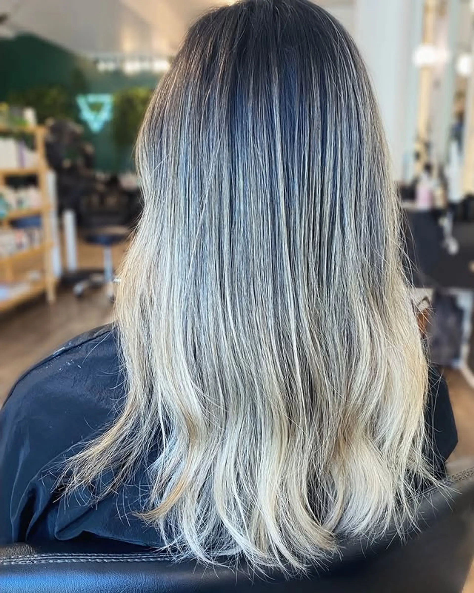 A chic ash blonde ombre with soft waves, perfect for a trendy and low-maintenance look. 1