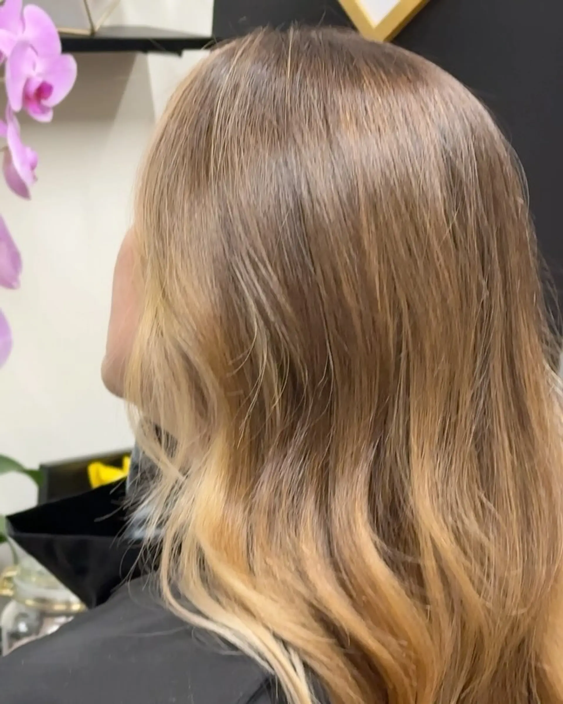 Medium-length layered hair featuring warm golden-blonde highlights styled into soft, flowing waves. 1