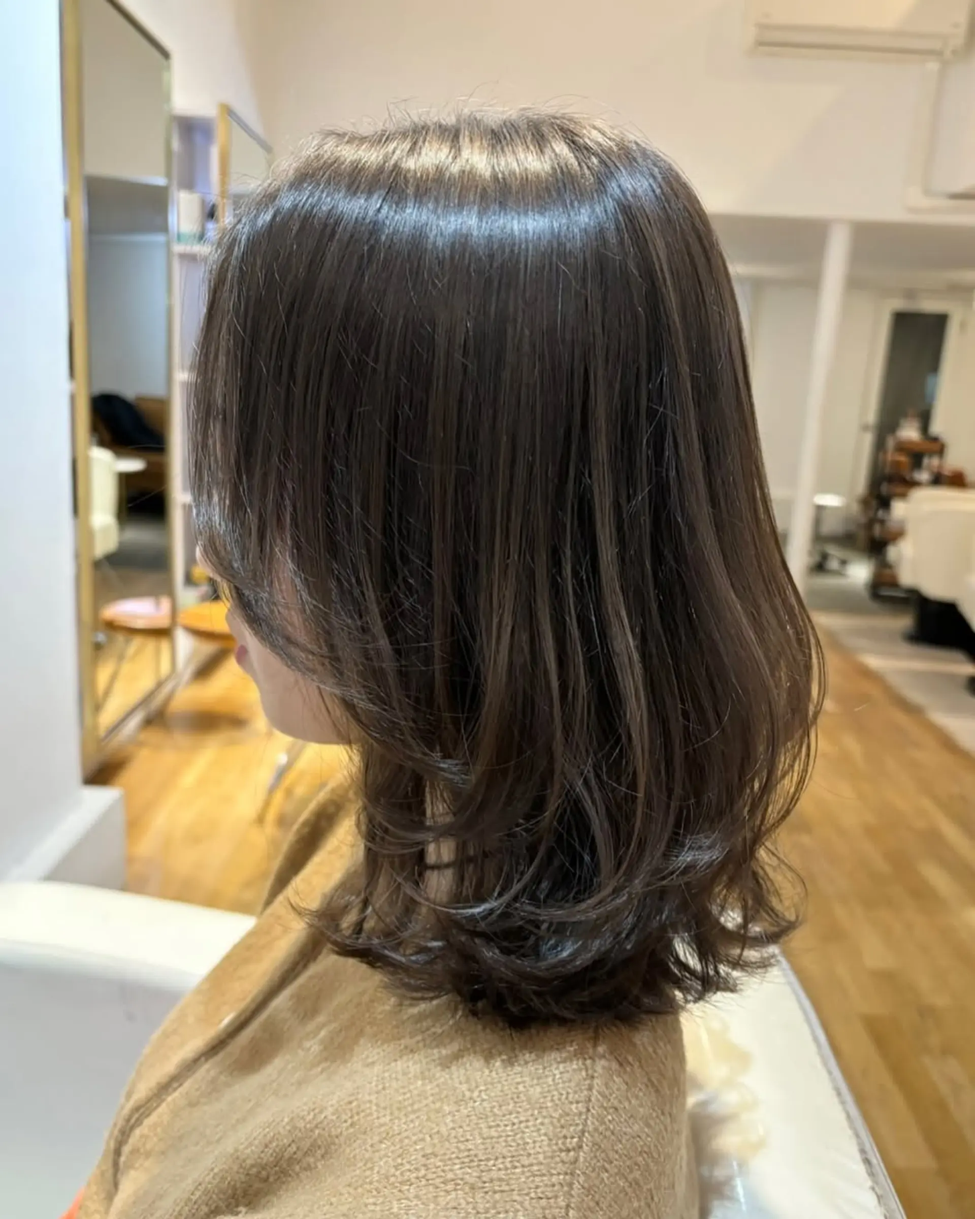 A stylish layered midi haircut with subtle face-framing layers. 1