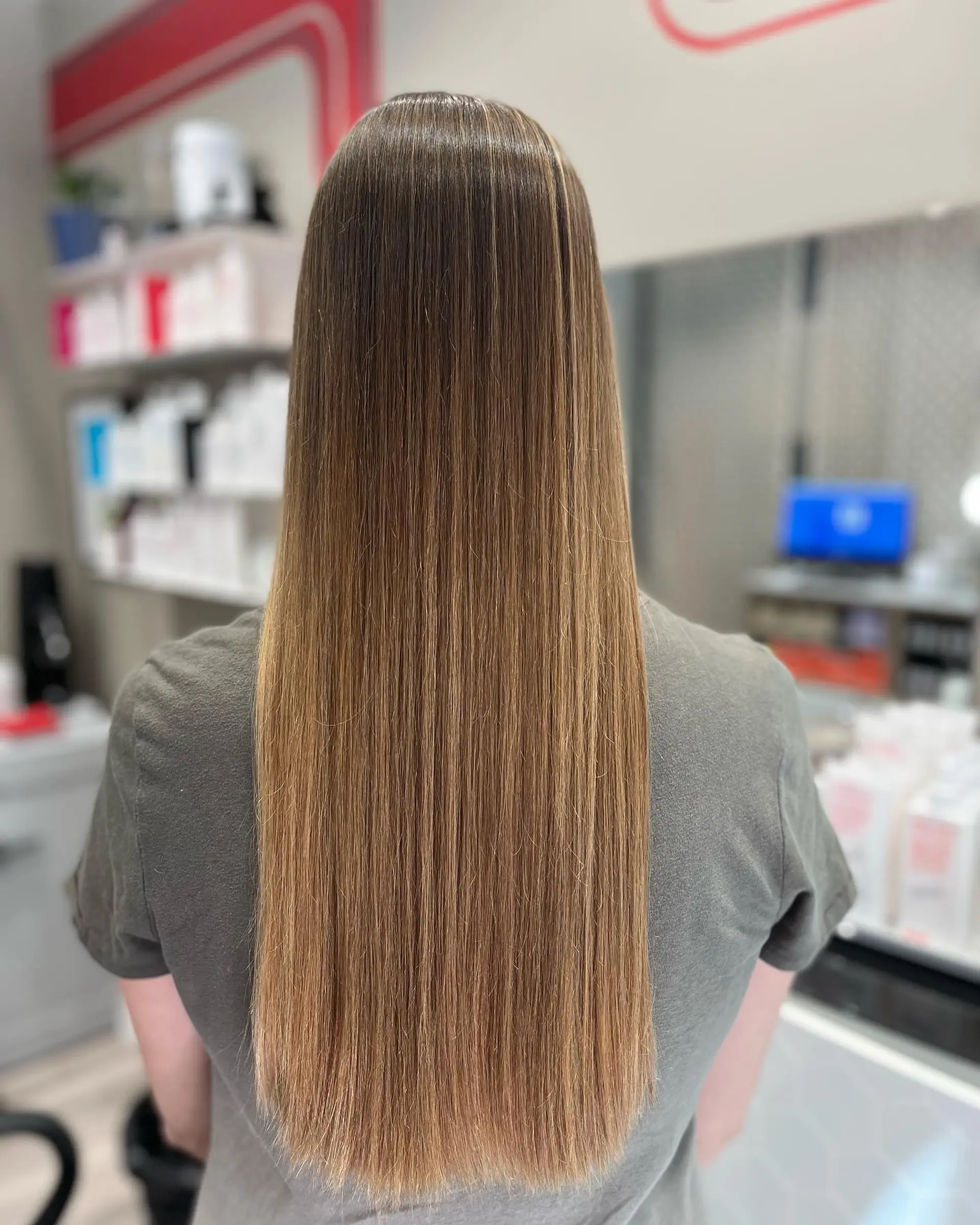 Long, straight hair with a brown to honey blonde ombre. 1
