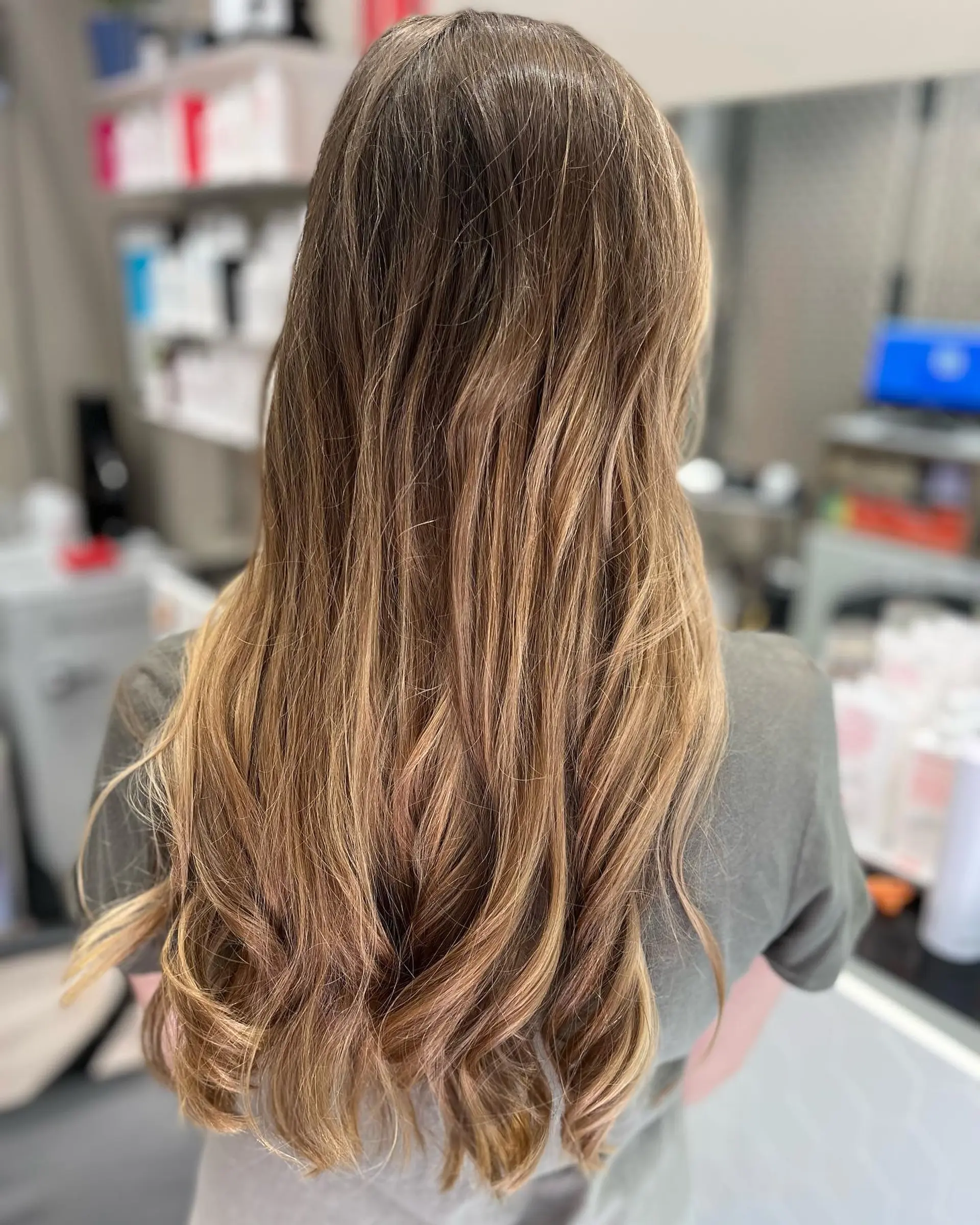 Long, straight hair with a brown to honey blonde ombre. 2