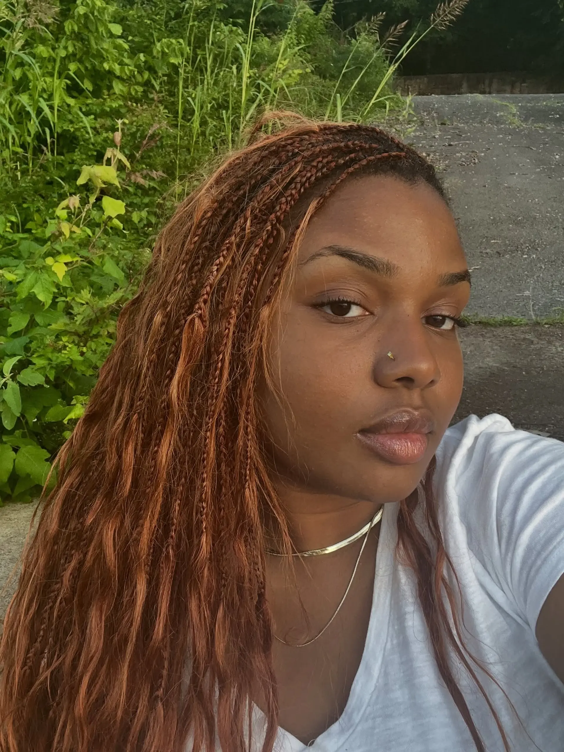 Long copper-auburn boho box braids with loose wavy texture throughout. 1