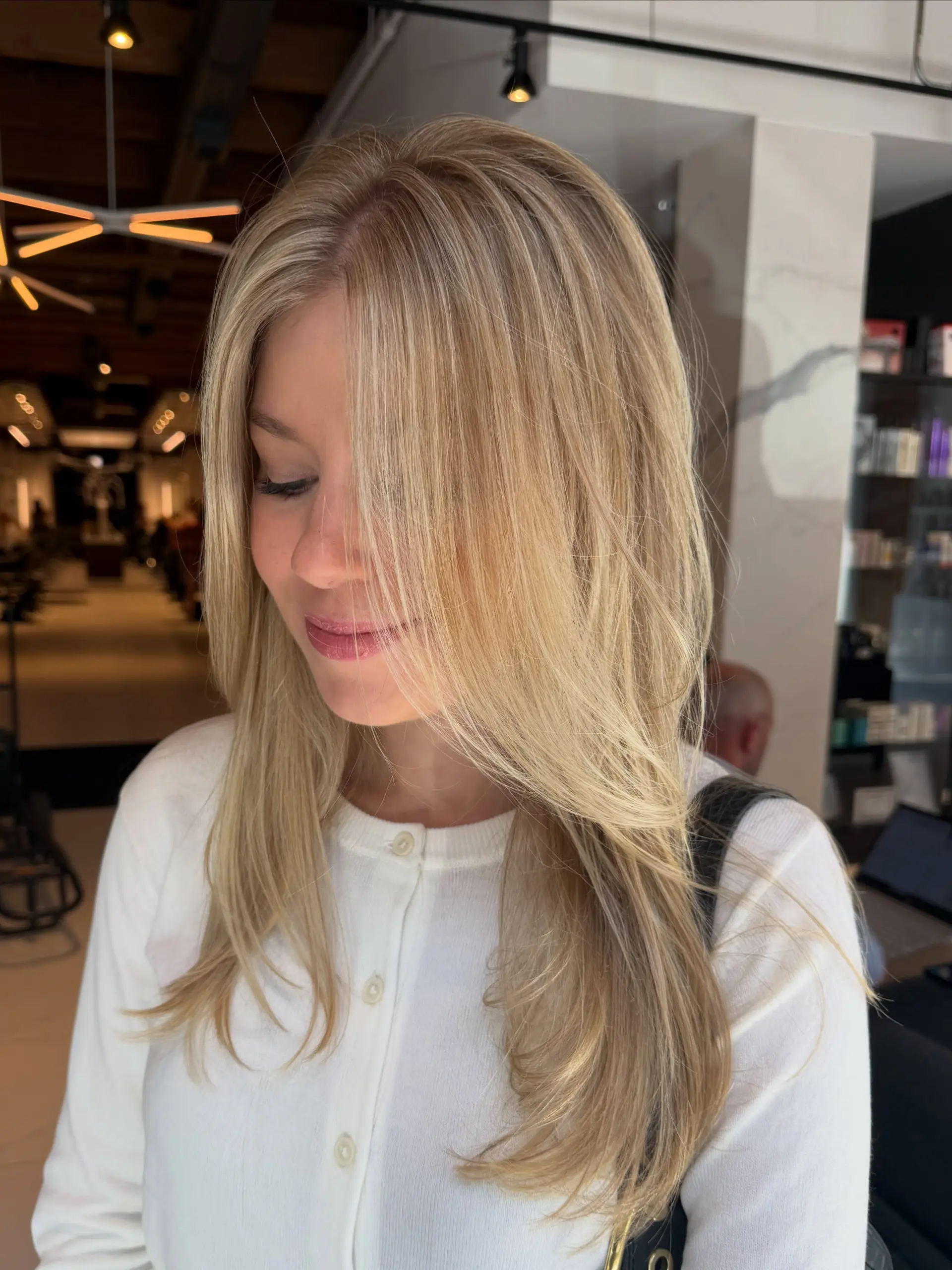 Long dimensional blonde layers styled with a smooth, soft blowout. 1