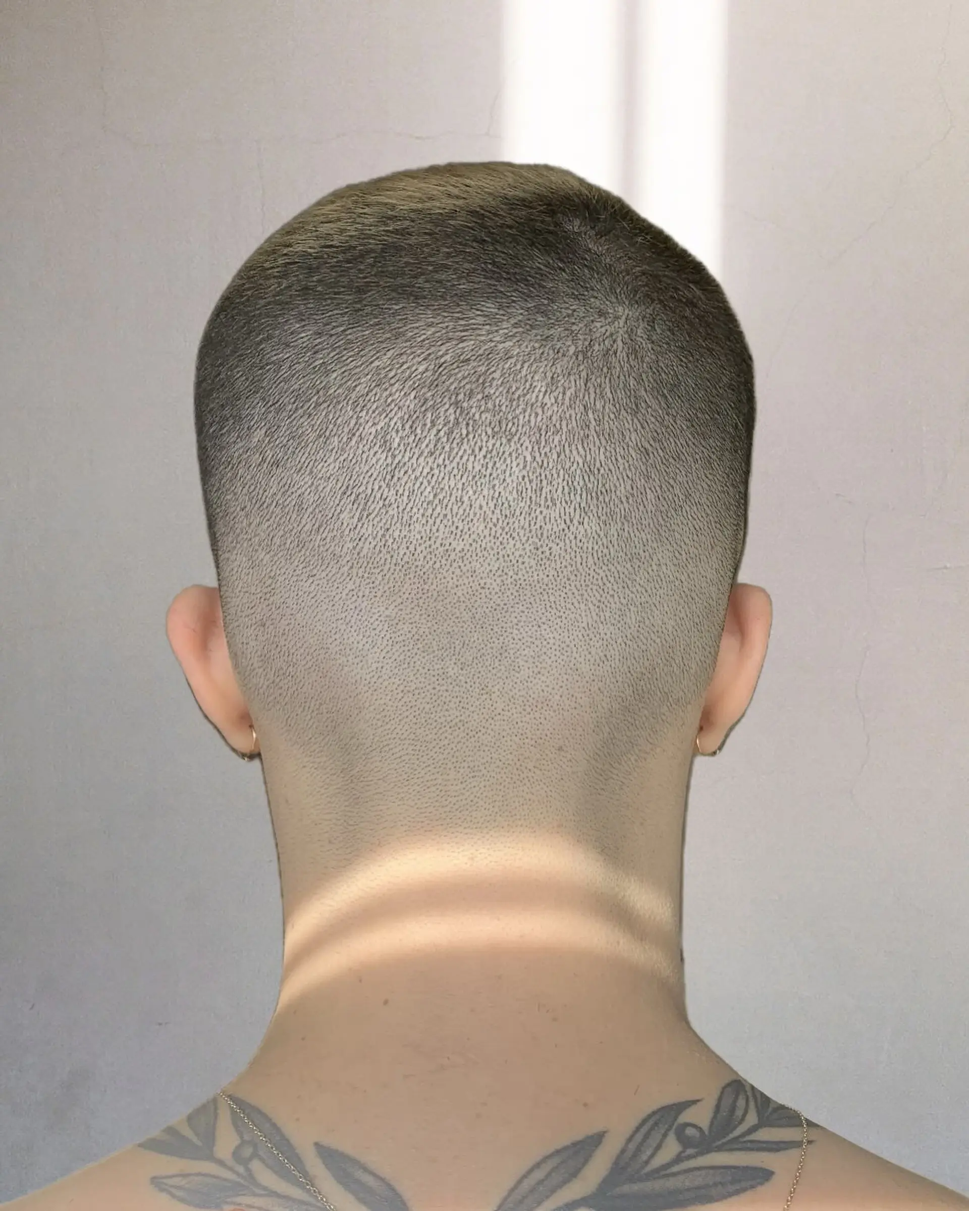 An ultra-short buzz cut with a seamless, clean fade down to the skin along the neckline. 1