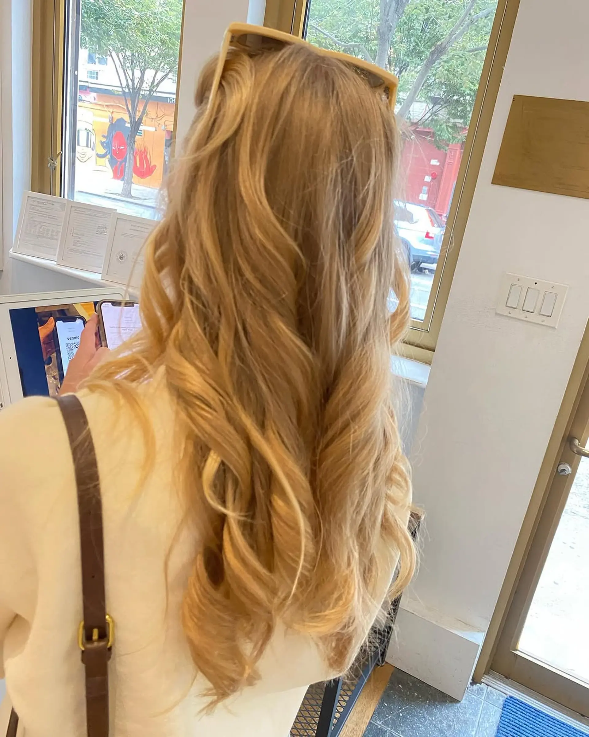 A long, wavy hairstyle with defined curls at the ends, worn in a half up style. 2
