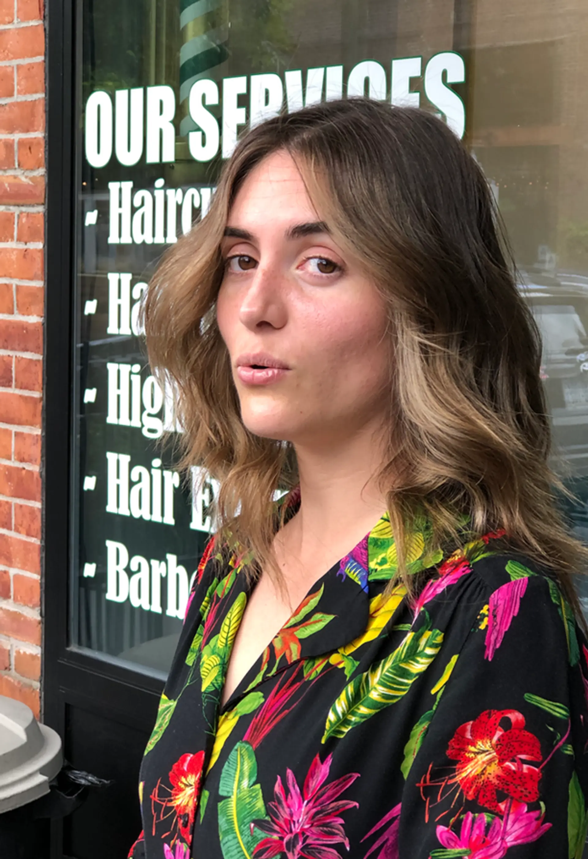 Medium-length wavy light brown hair with blonde highlights and face-framing layers, styled into soft, relaxed waves. 1