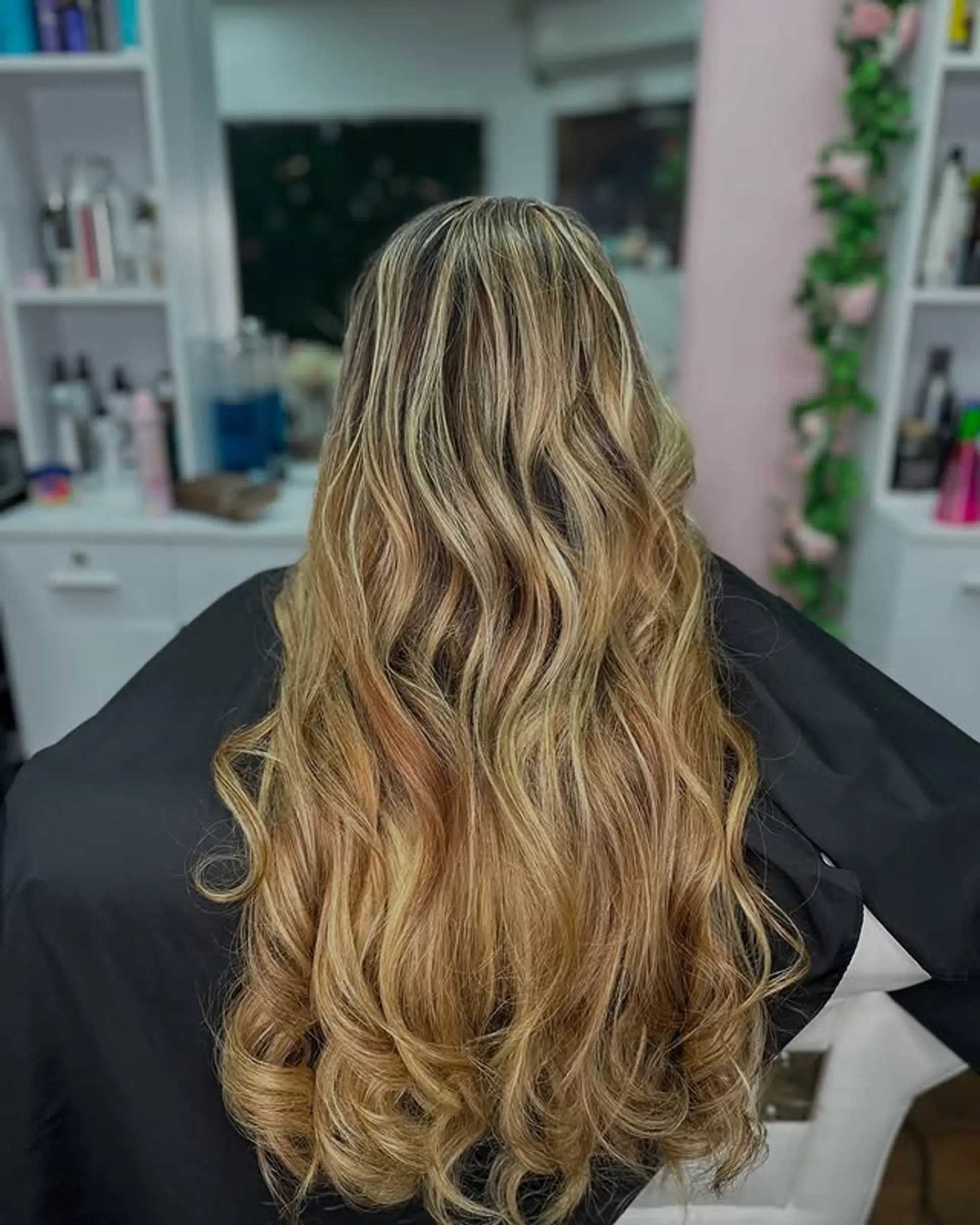 Long, wavy, and layered hairstyle with balayage highlights. 1