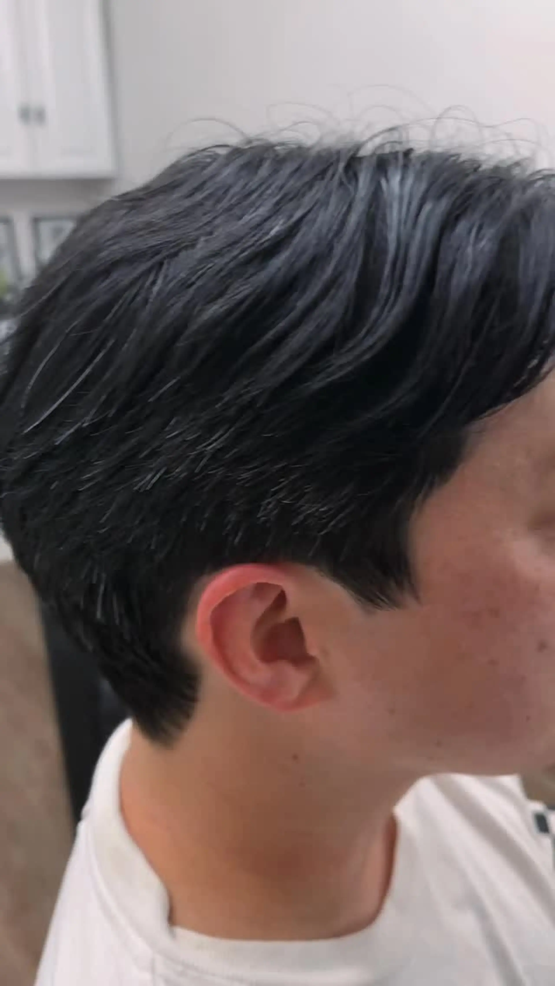 A textured short haircut featuring soft scissor tapering around the ears and neck with natural length and flow preserved on top. 1