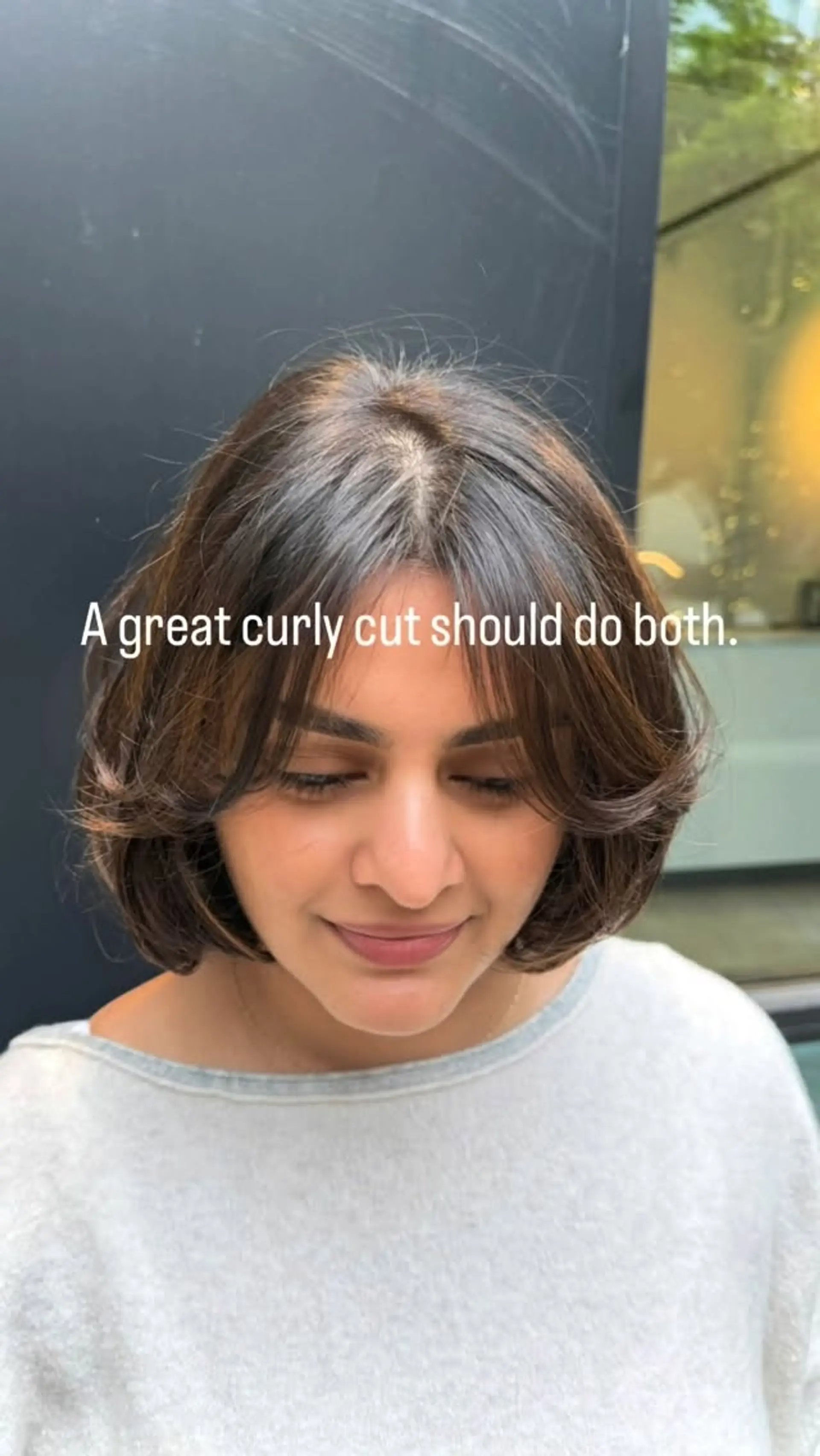 A chin-length layered brunette bob styled with soft flipped ends and parted curtain bangs framing the face. 1