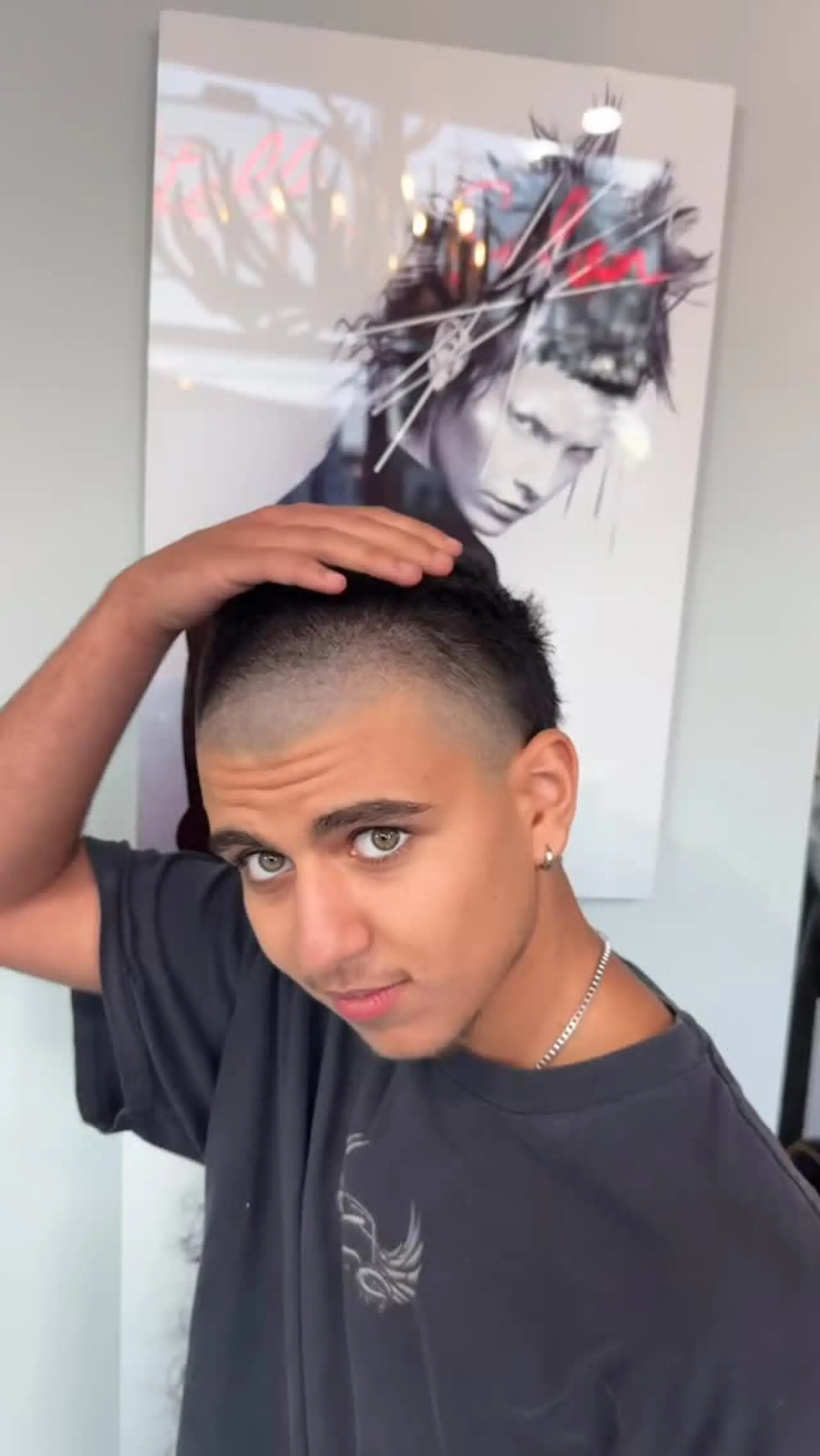 An edgy skullet featuring a closely shaved buzz cut along the front and crown paired with tapered sides and length preserved at the back. 1
