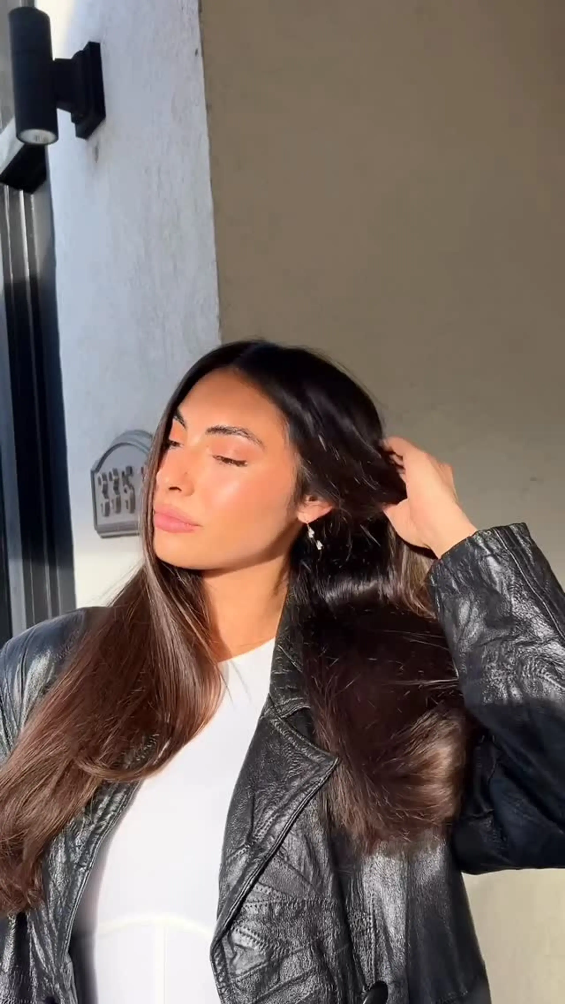 Long, rich dark brown hair styled in a smooth, glossy blowout with soft volume and beveled ends. 1