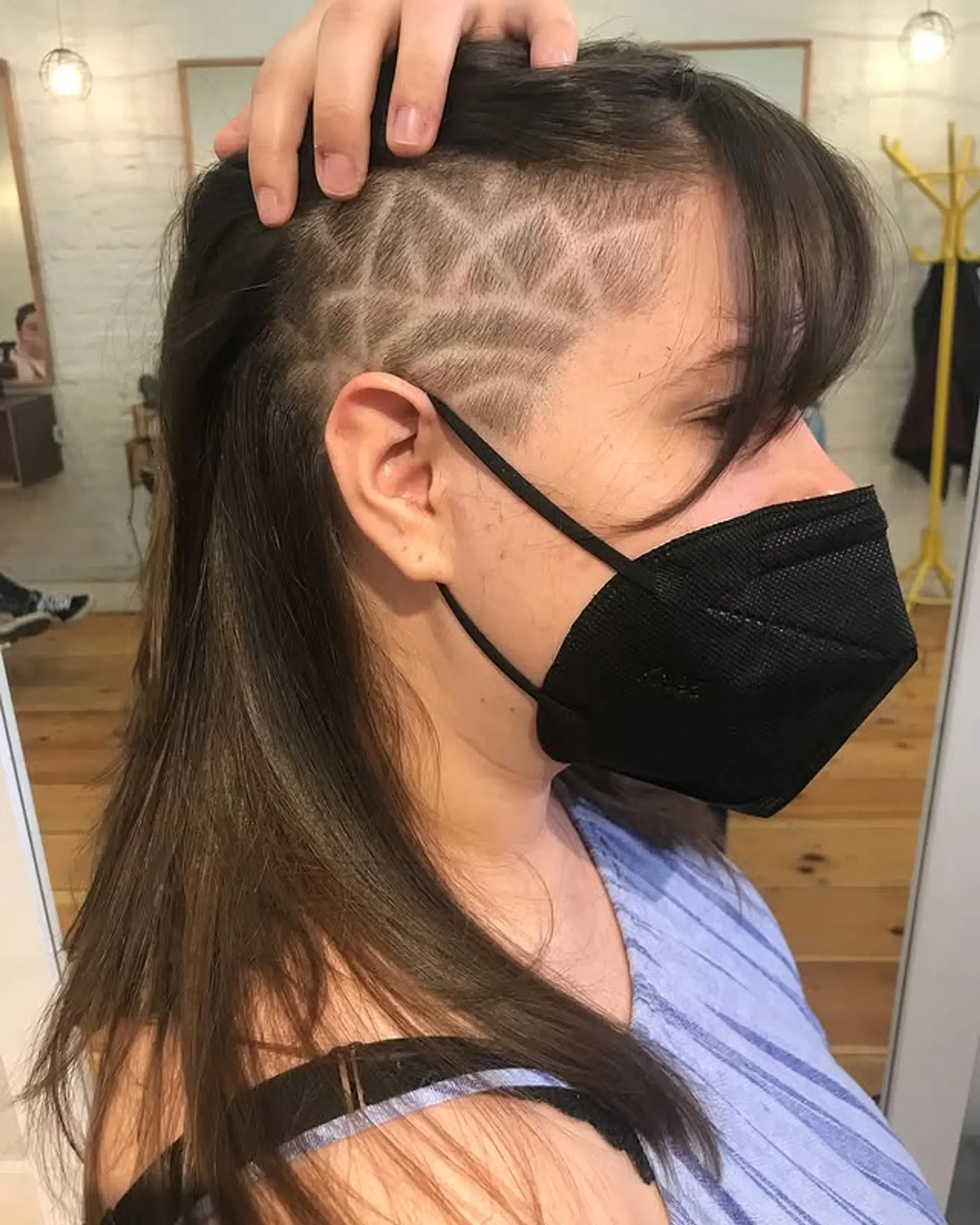 Long layered hairstyle with a geometric shaved undercut design. 1