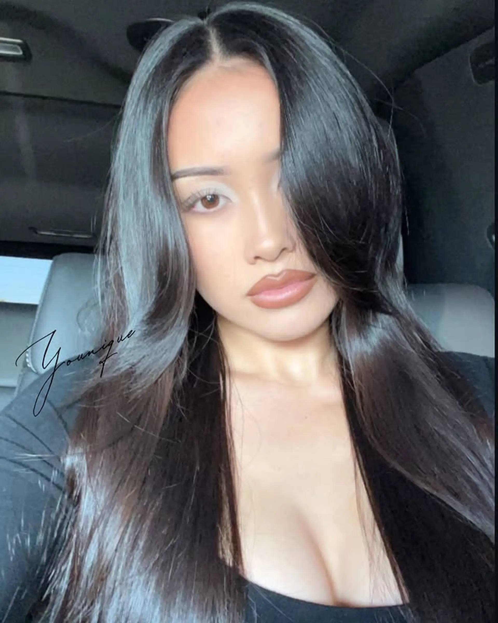 A sleek and elegant long hairstyle with a center part and subtle layers. 1