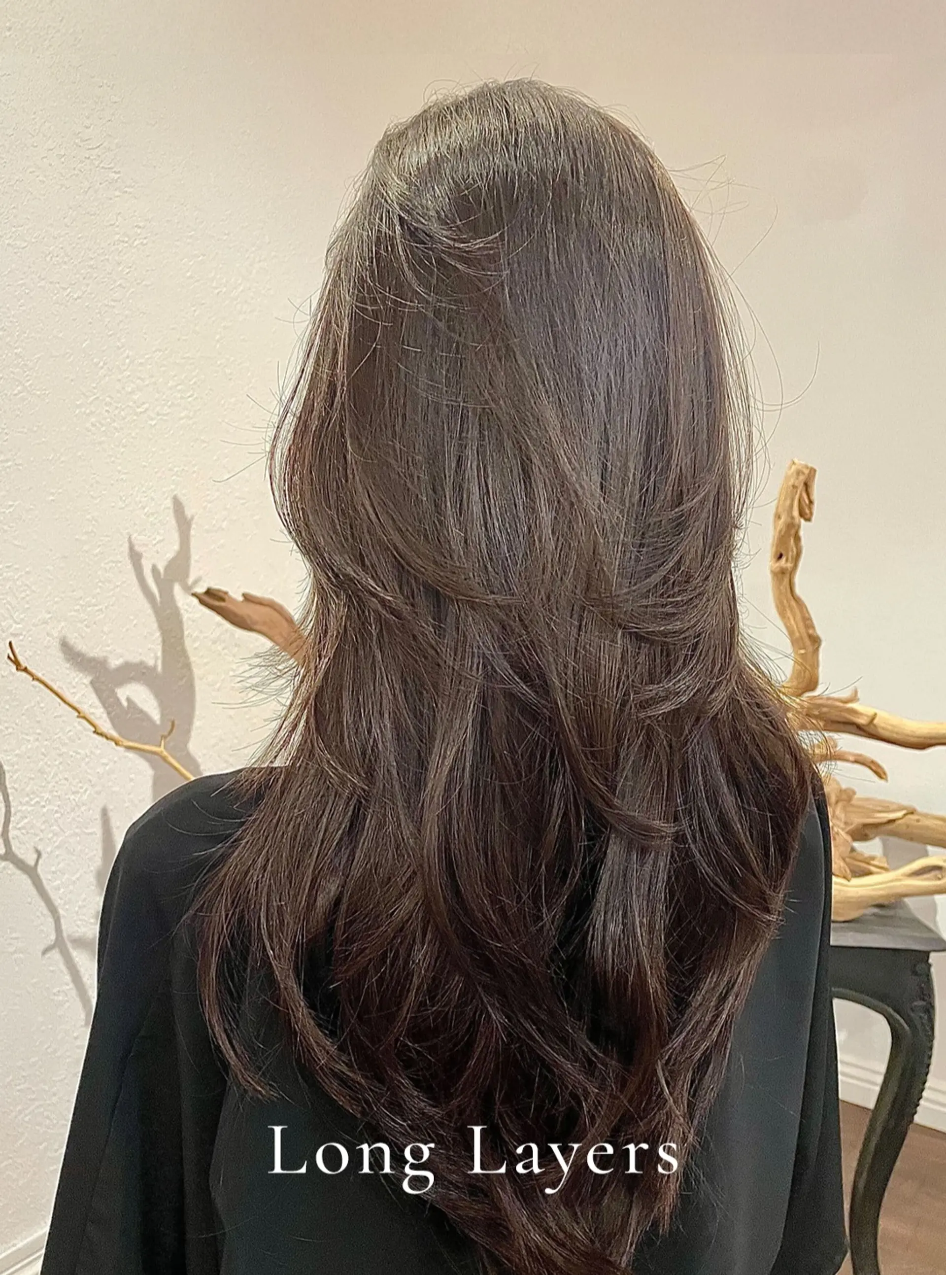 Long dark brown hair featuring seamless, face-framing precision layers with natural movement and a soft blowout finish. 1