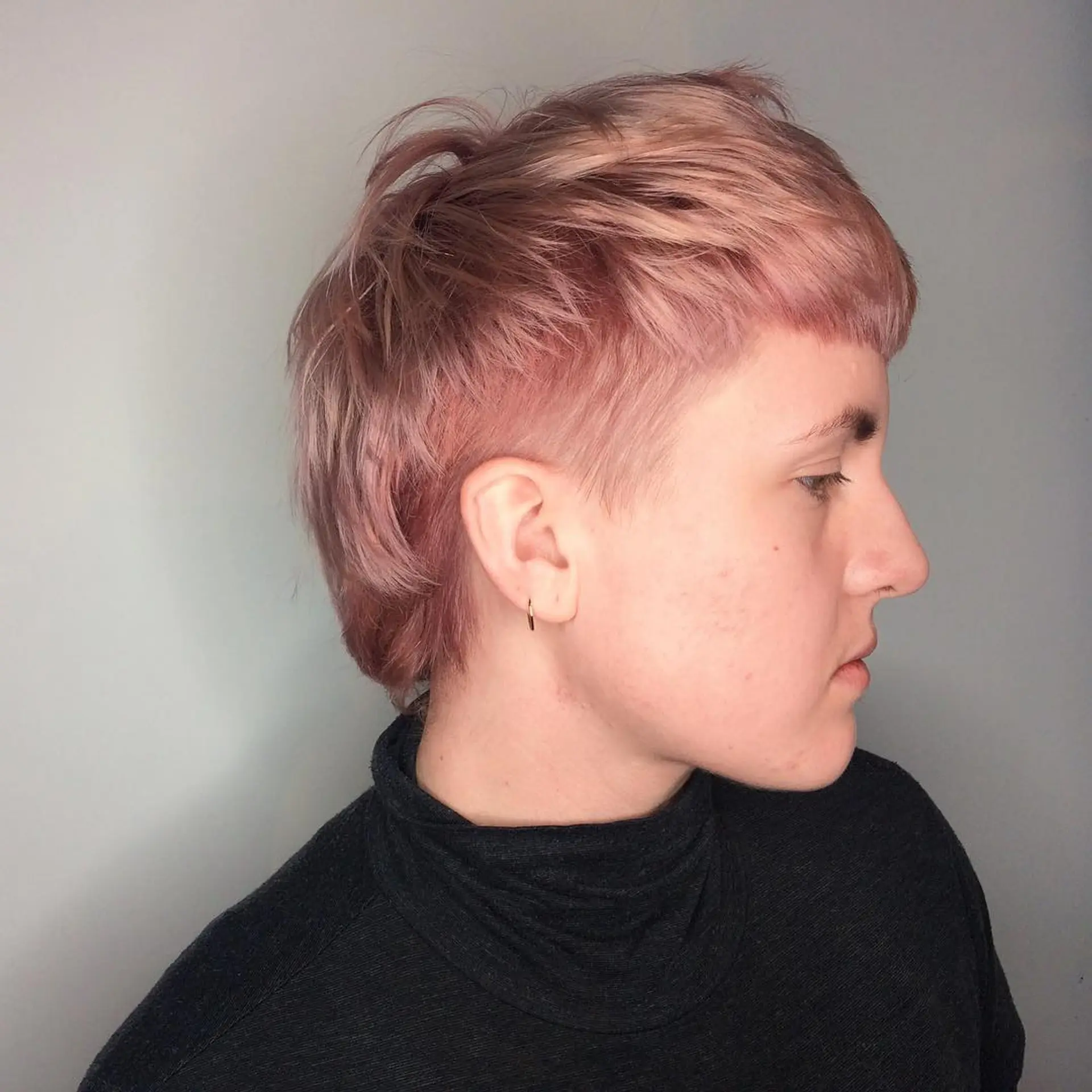 A modern shaggy mullet featuring edgy texture and a vibrant rose gold color. 1