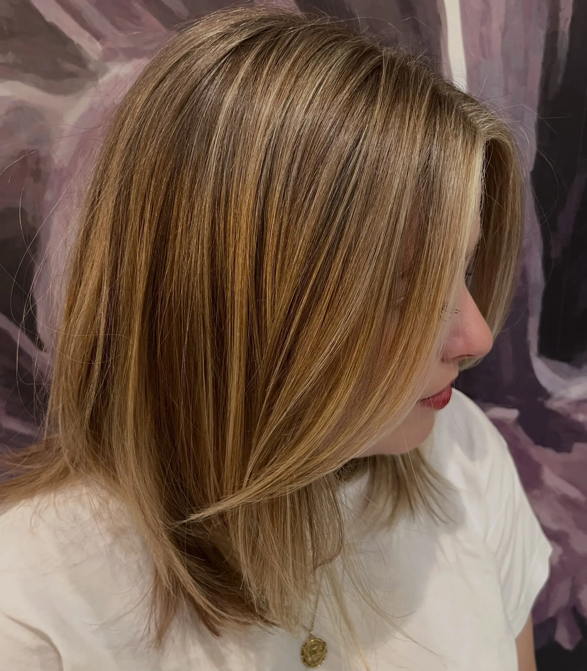 Medium-length straight cut styled with face-framing layers and dimensional blonde highlights. 1