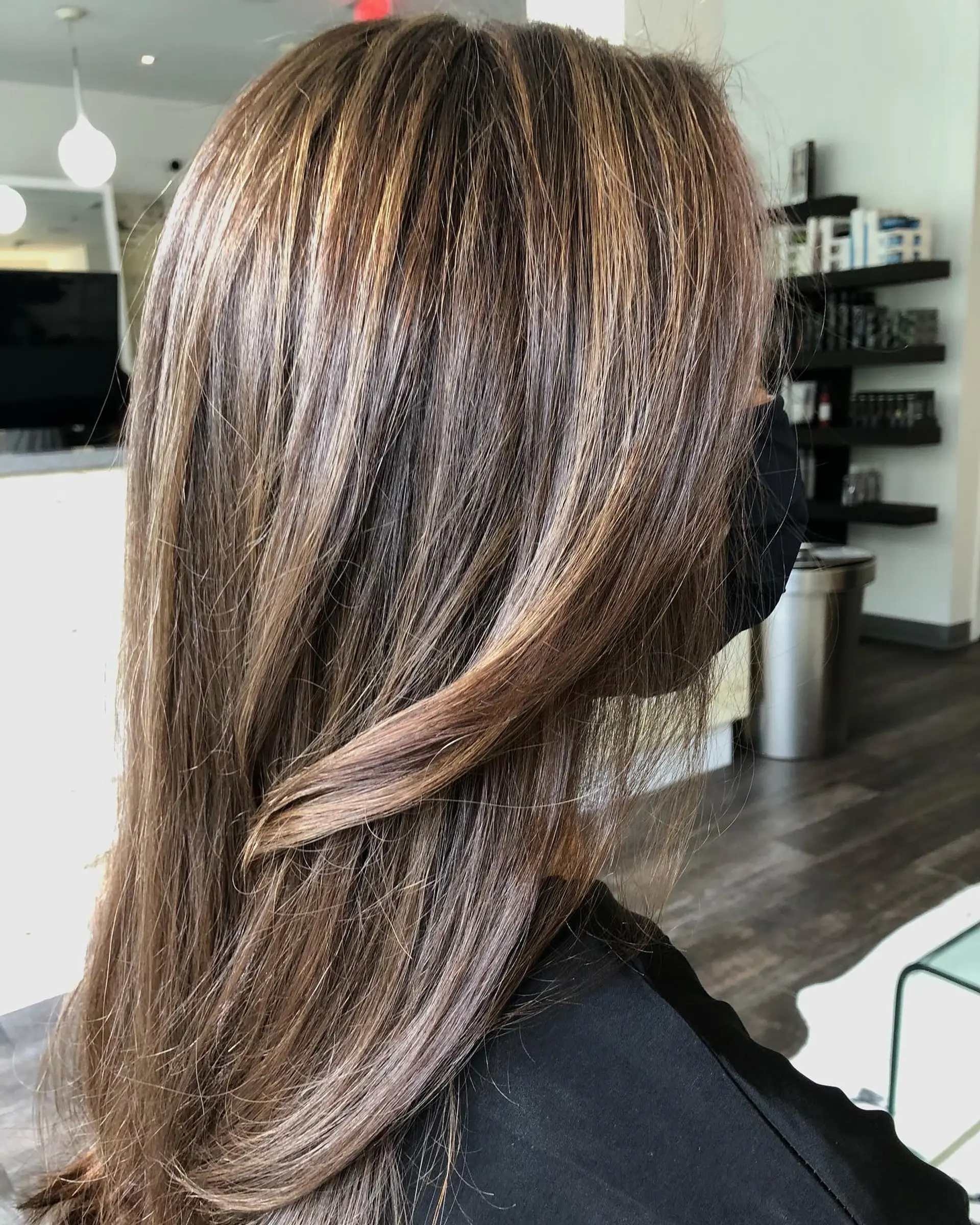 Long straight brunette hair detailed with fine multi-dimensional caramel highlights and lowlights. 1