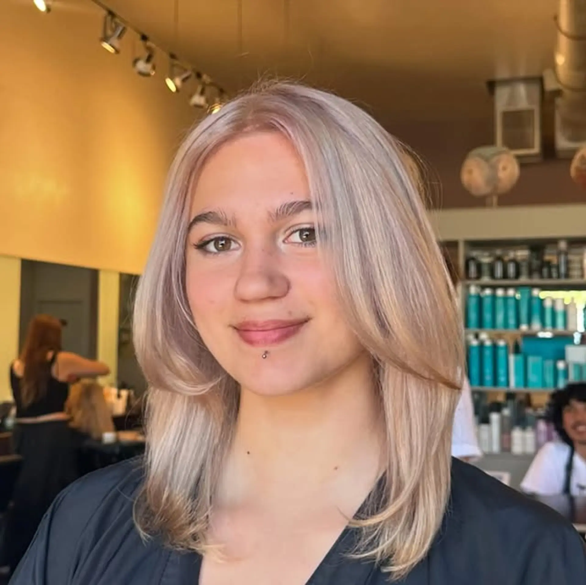 A layered bob with face-framing layers and an icy blonde toner. 1